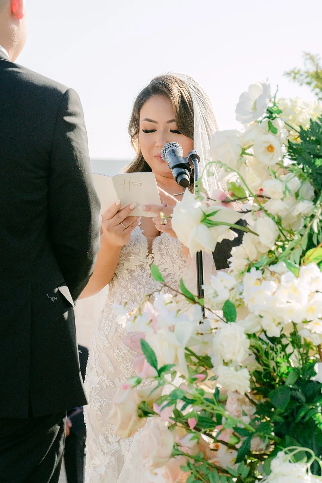 Candice reading her vows into the microphone