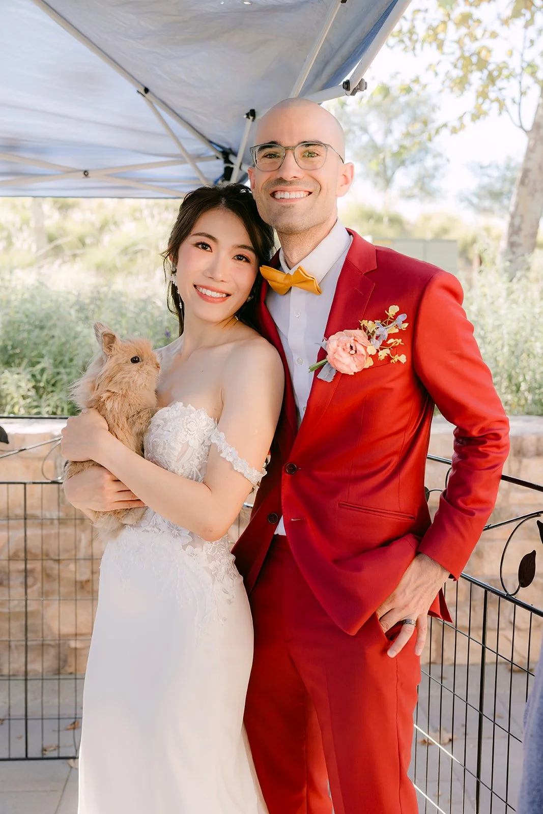 Christie holds a small furry animal while Christian smiles beside her.