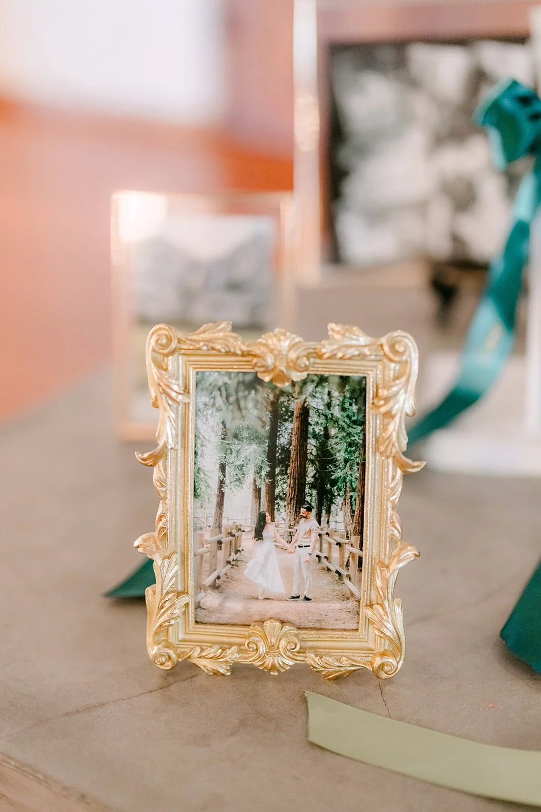 Gold framed photo of the couple at a place setting
