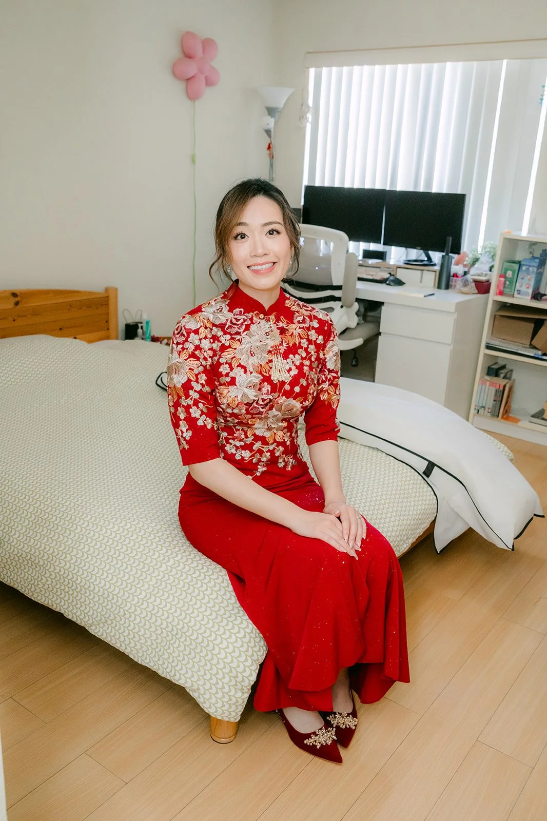 Pauline waiting on the bed in her qipao.