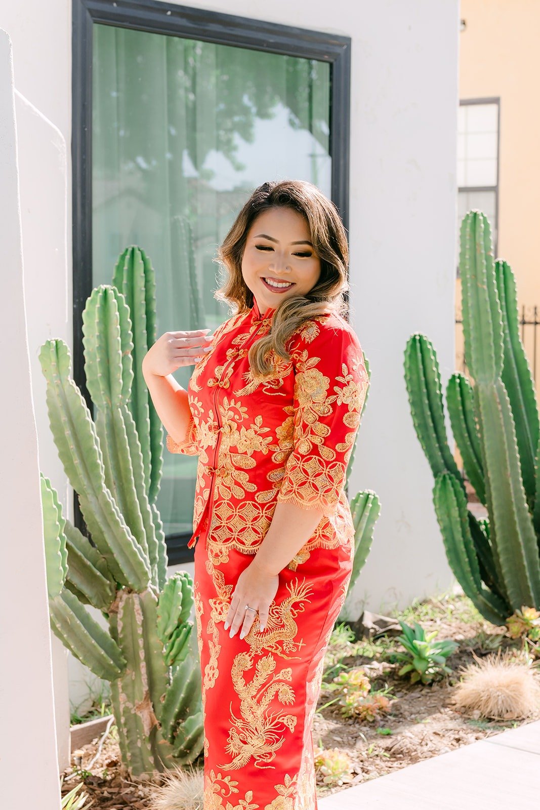 Candice in her red qipao by the cactus garden