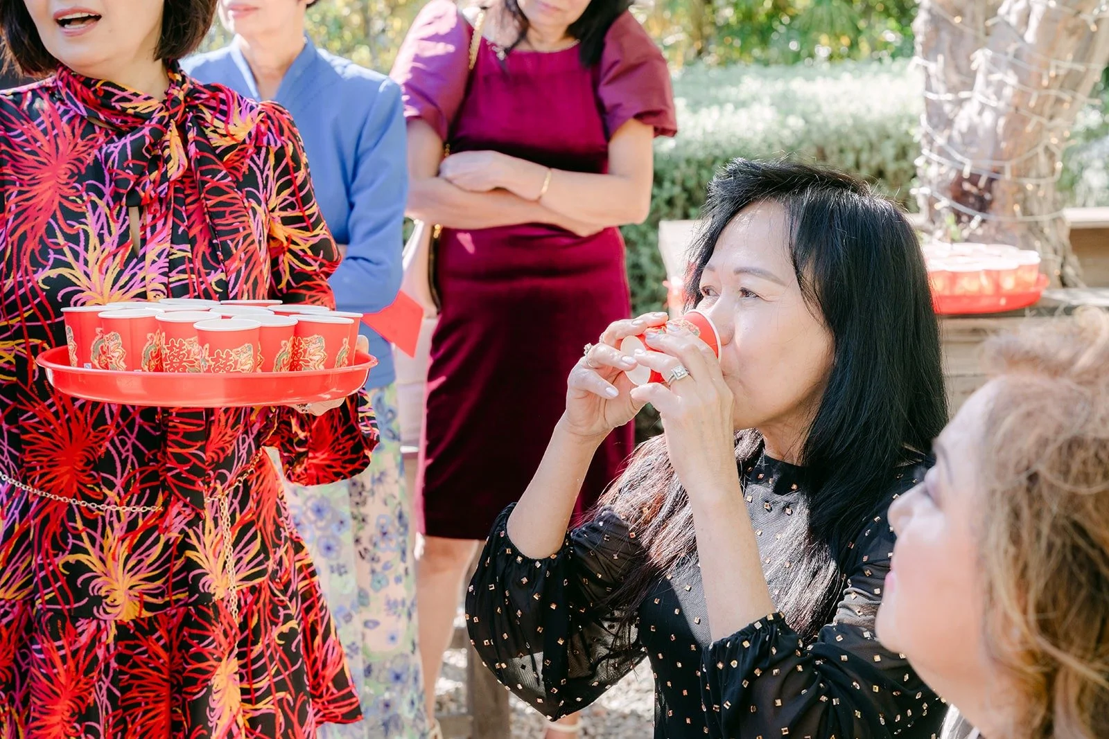 A family member sipping tea during the ceremony