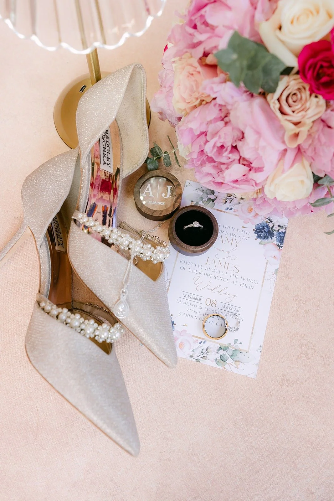 Wedding details with heels, rings and a pink peony bouquet