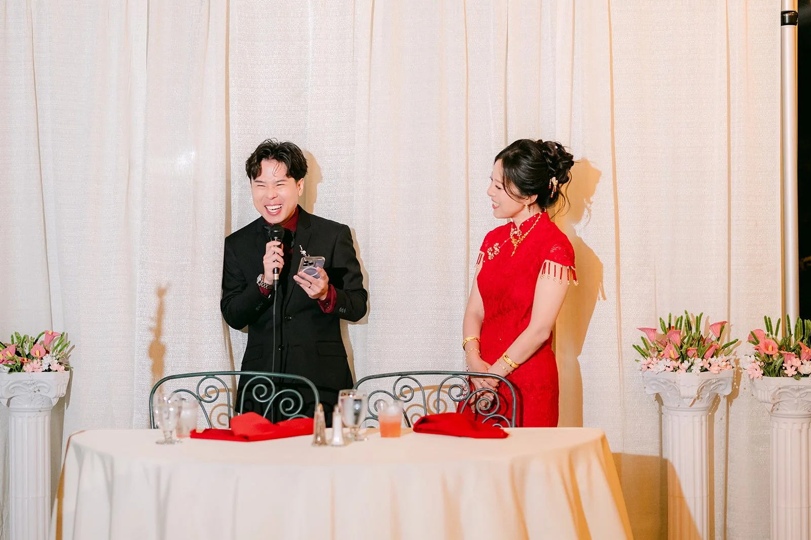 Wen singing as Elaine smiles beside him.