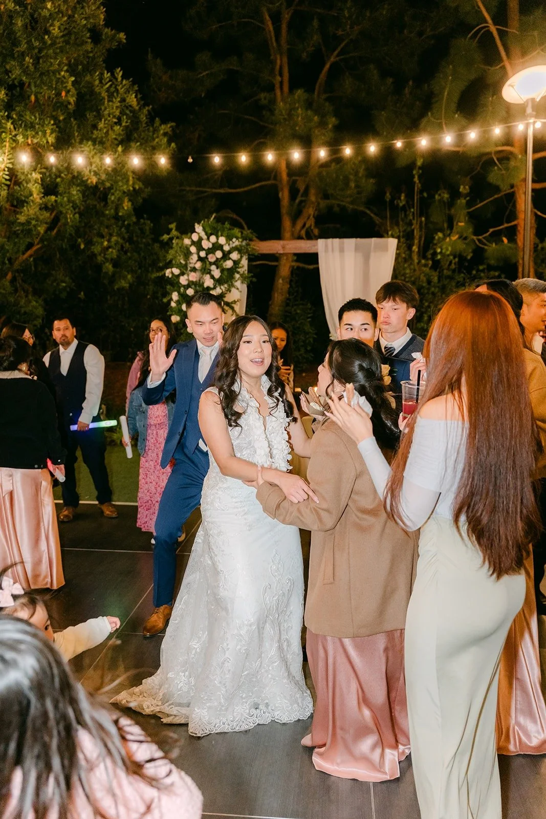 Kelli dancing with her friends under the string lights