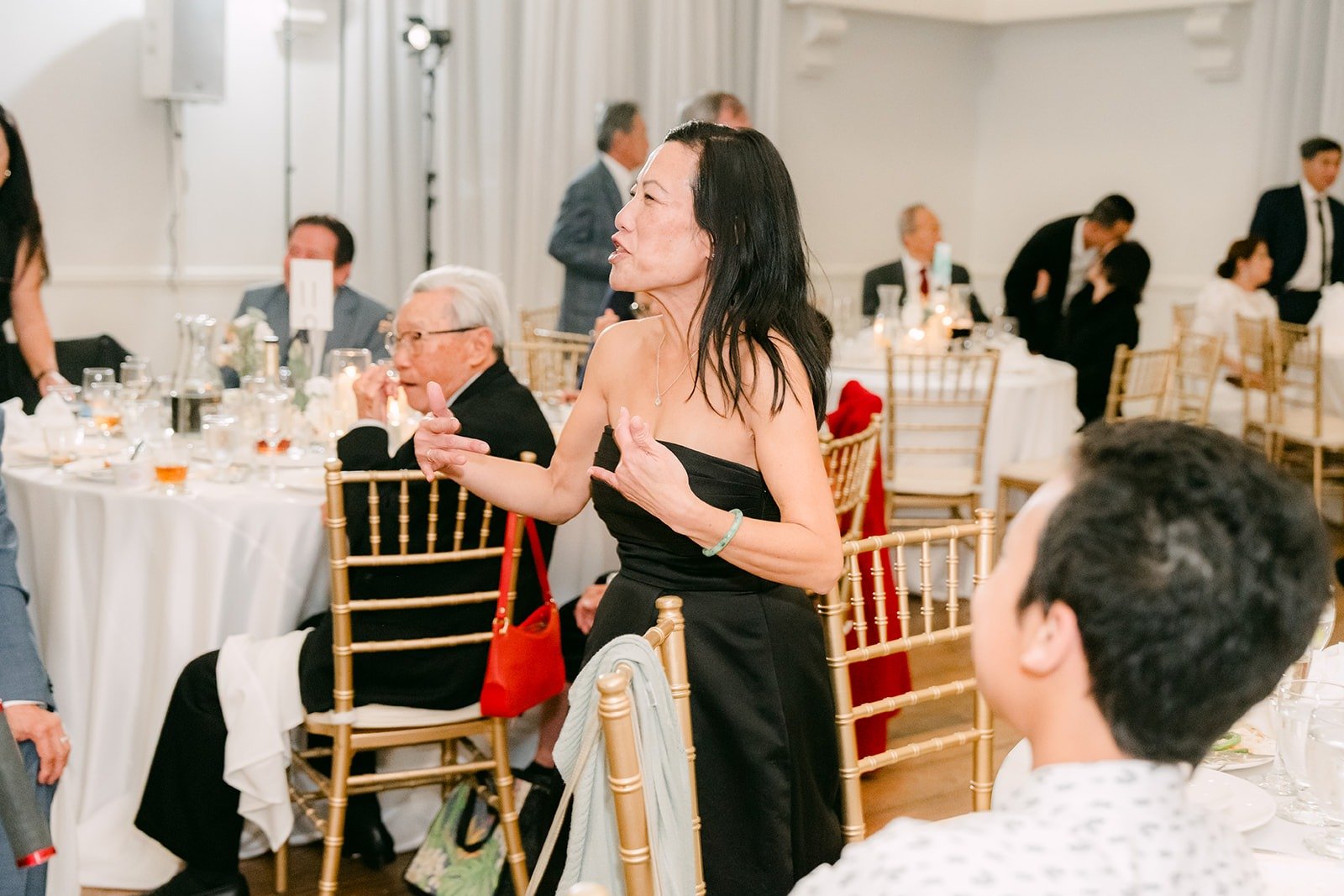 A guest cheering from her seat during the games
