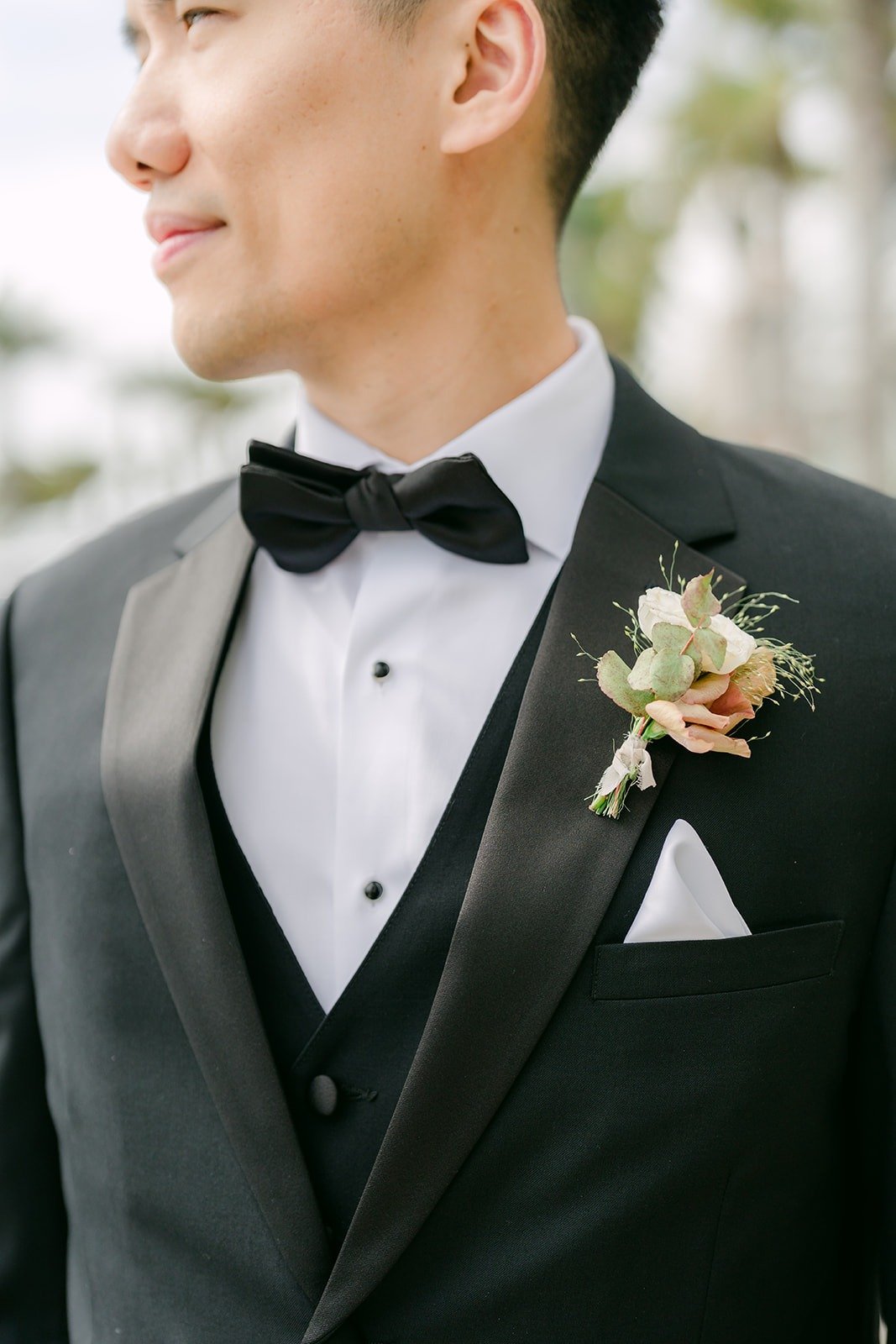 Close up of Eli's bow tie, vest and boutonniere