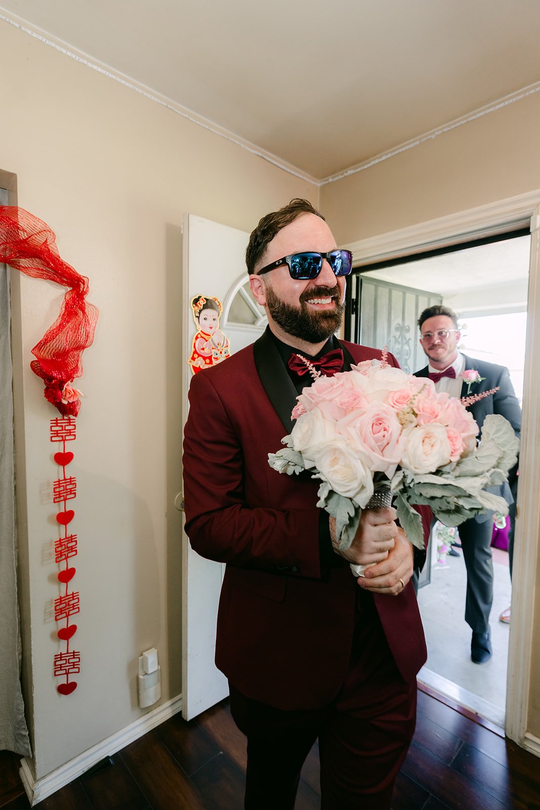 Ryan walking in with the bouquet.