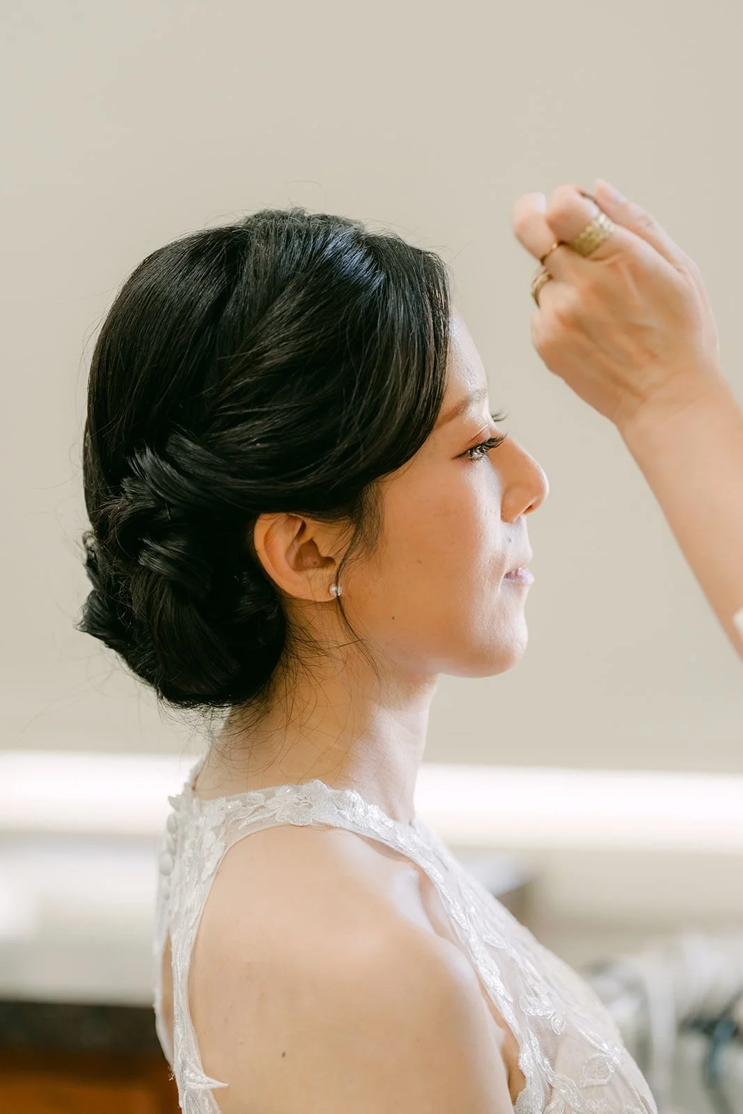 Elaine's makeup touch-up, her hair in a low updo.