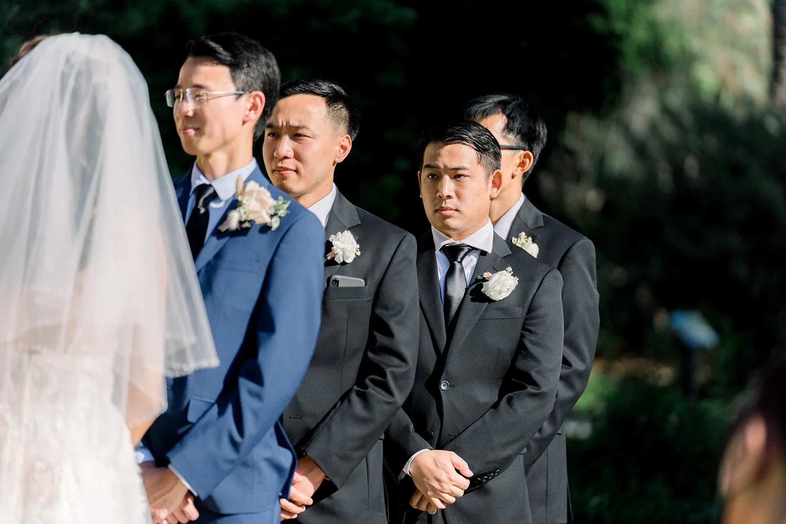Alex and his groomsmen watching Ariel during the vows