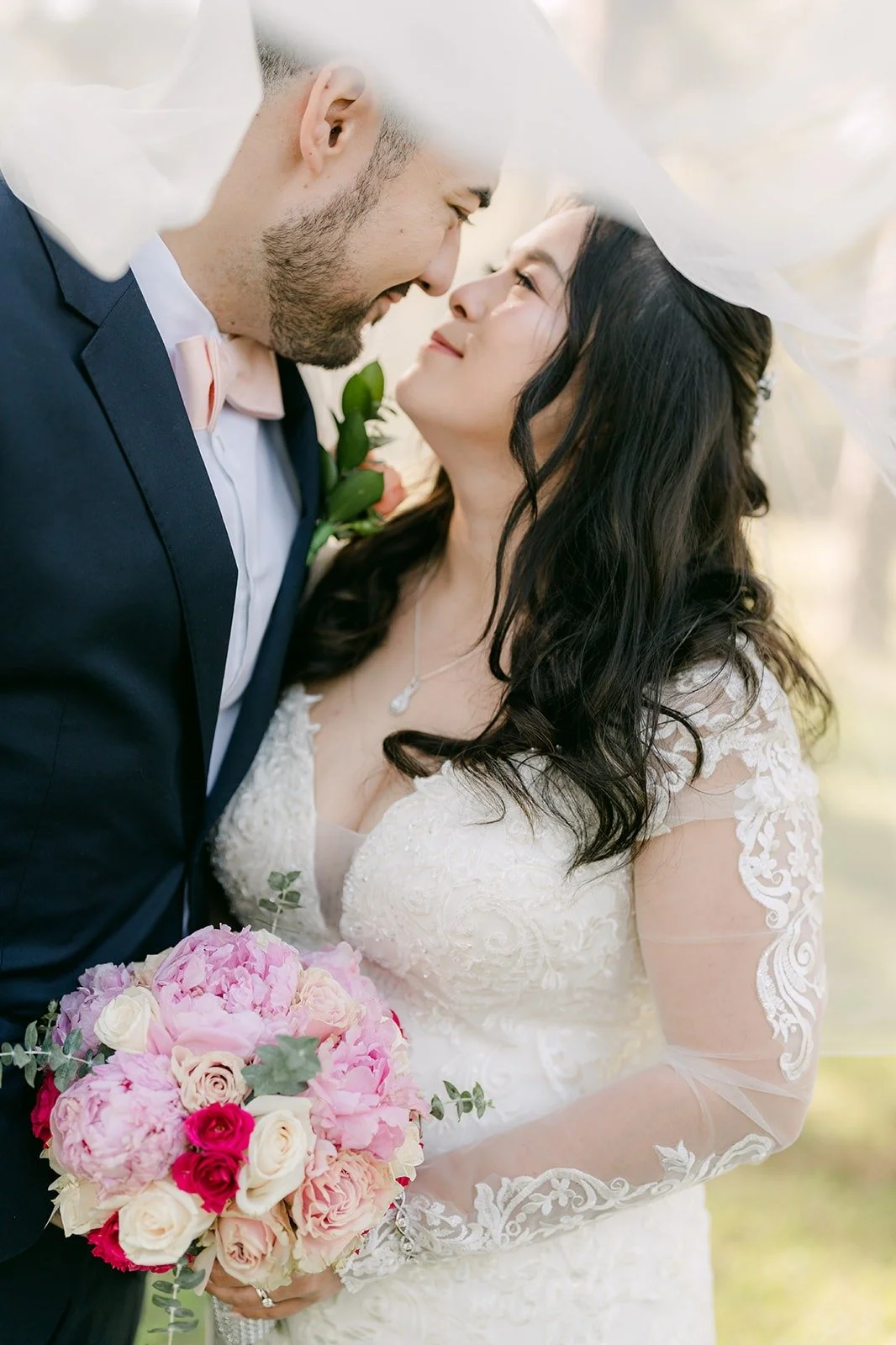 James leaning in for a kiss as Amy holds her bouquet