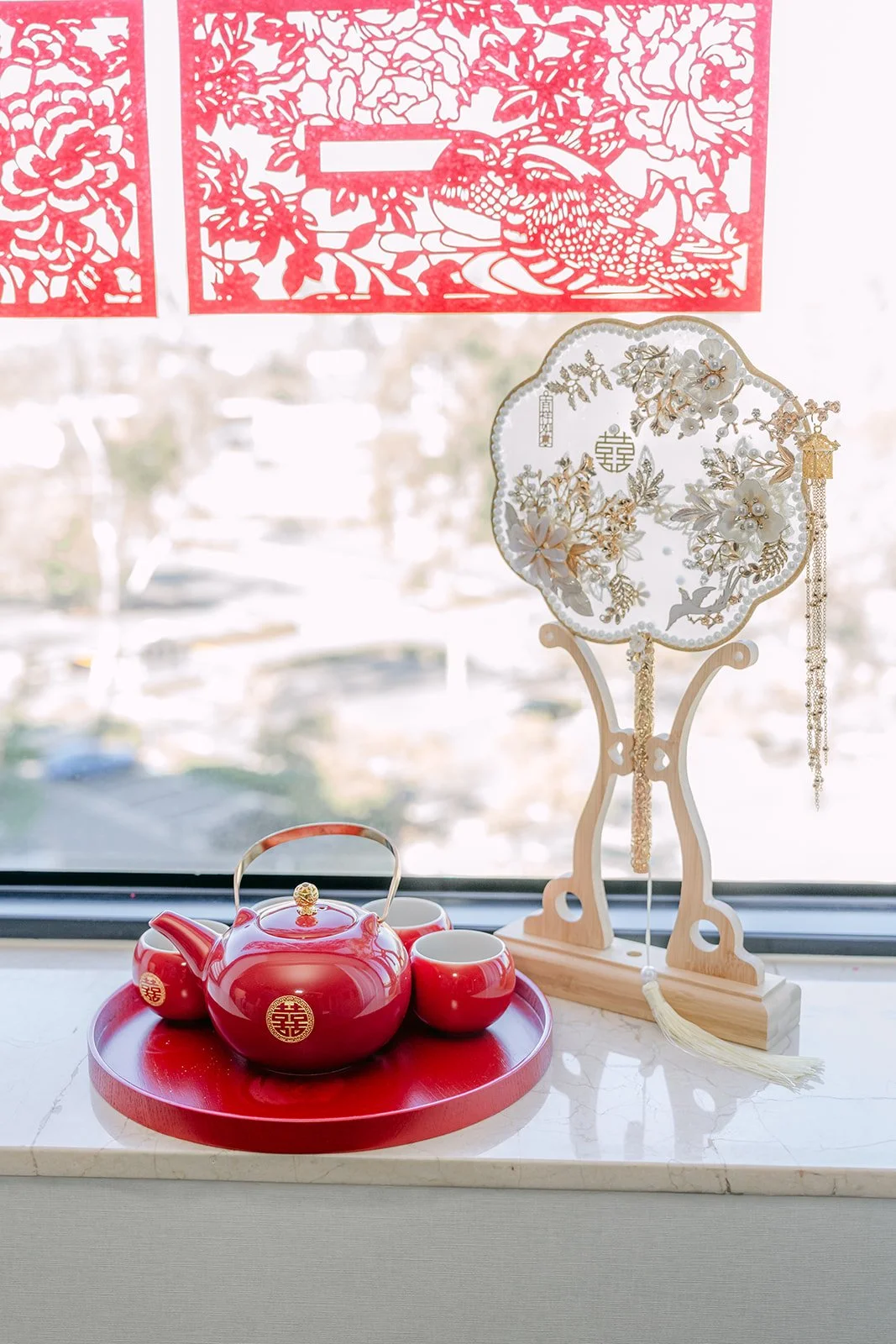 The tea set and red double happiness decor ready for the tea ceremony by the hotel window.