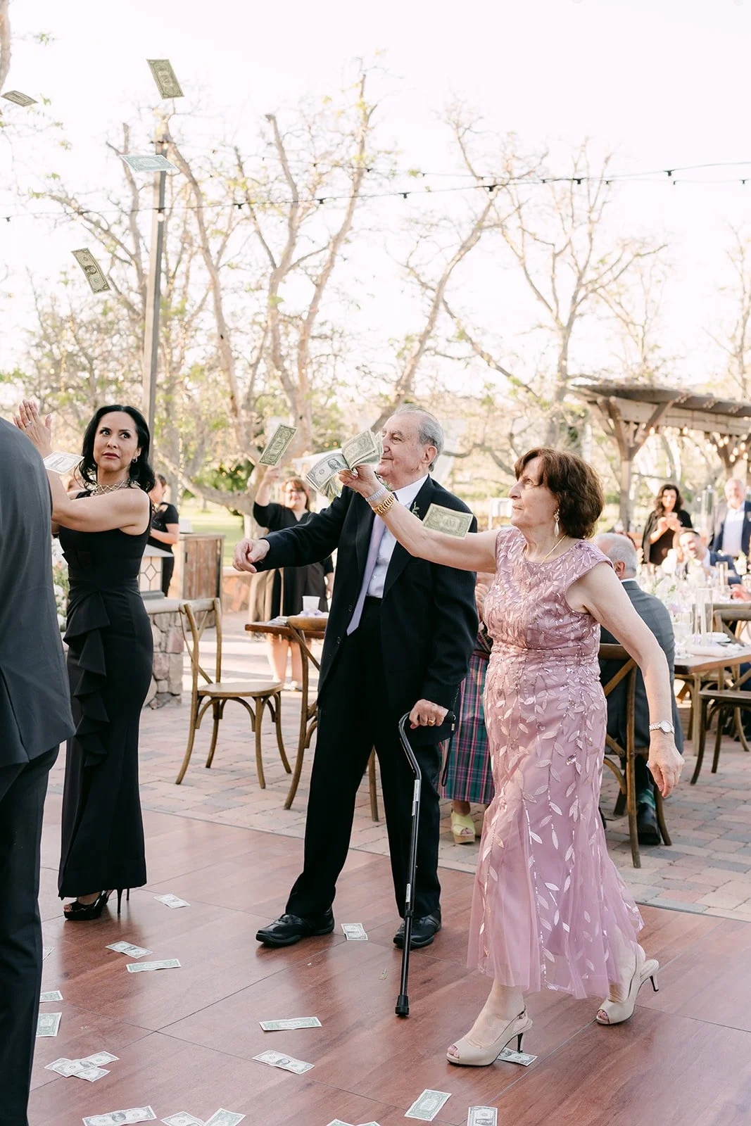 Family dancing and tossing money on the dance floor