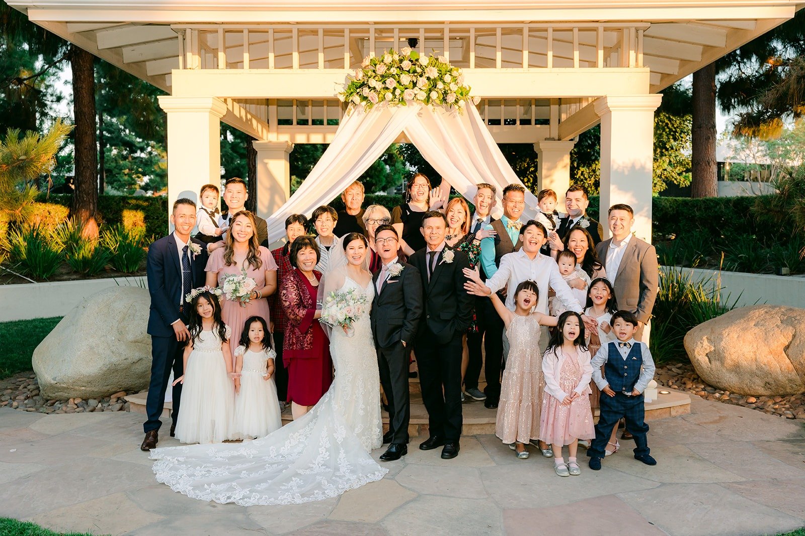 Xuemin and Alex with family in front of the gazebo, photographed by One and Only Production
