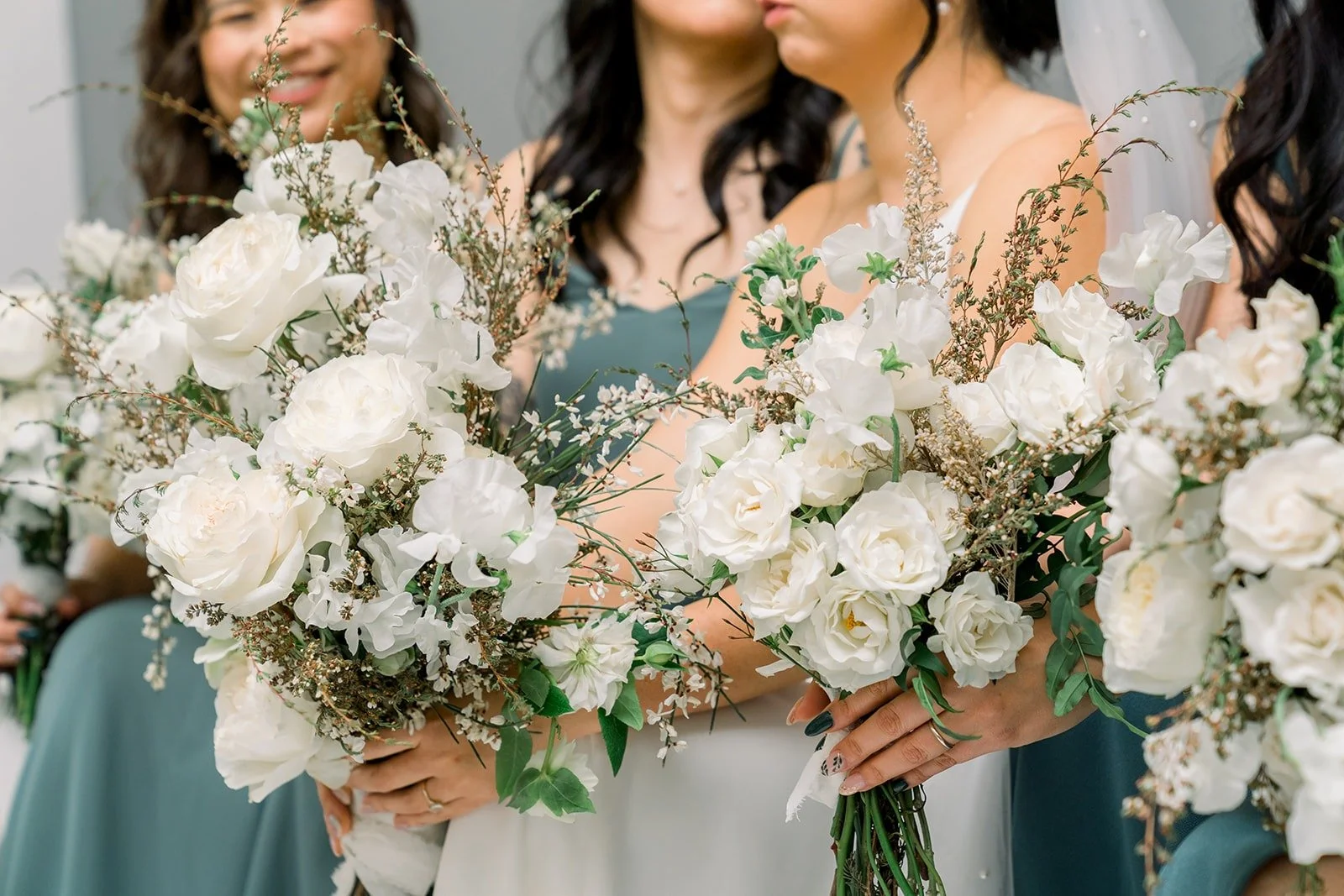 Close up of Cindy and her bridesmaids holding white bouquets