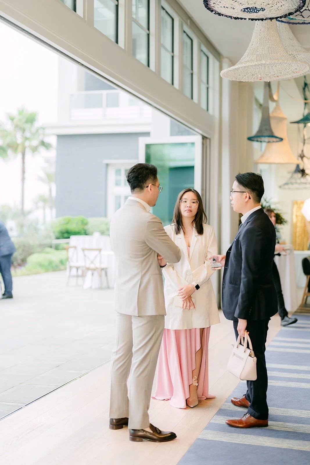 Guests chatting by the windows during cocktail hour
