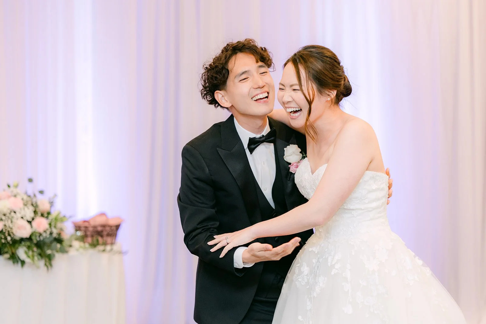 Couple laughing cheek to cheek during the first dance