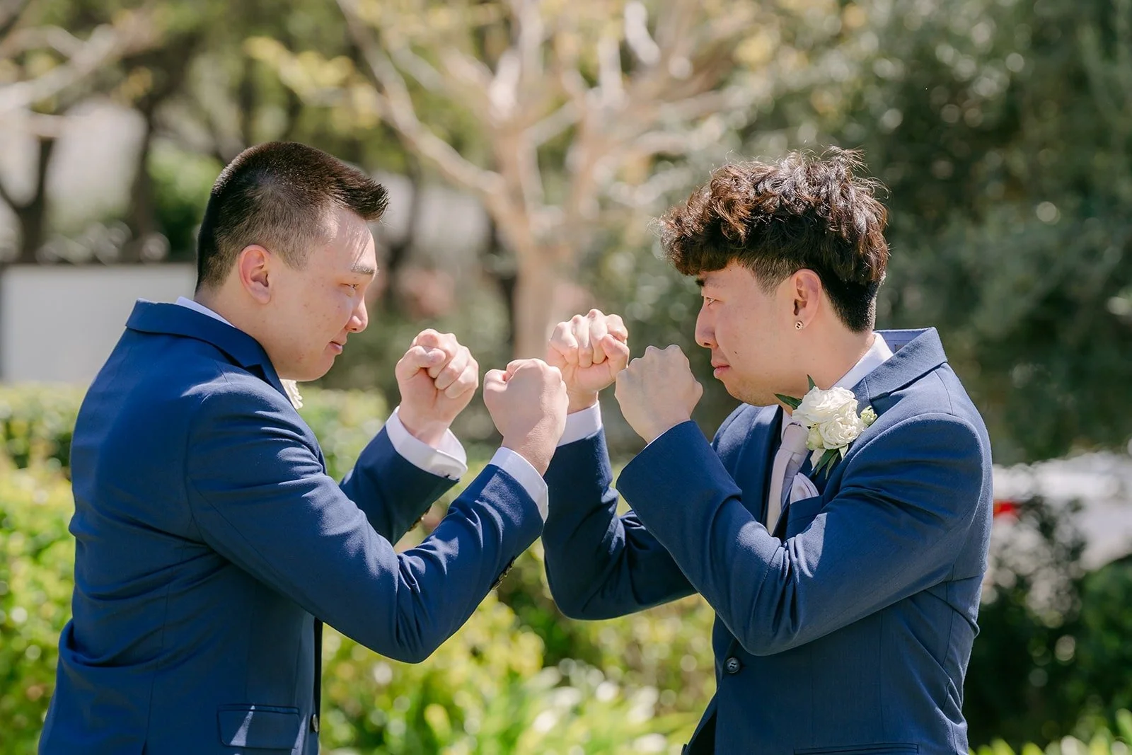 Alex sharing a fist bump with a groomsman before the first look, photographed by One and Only Production