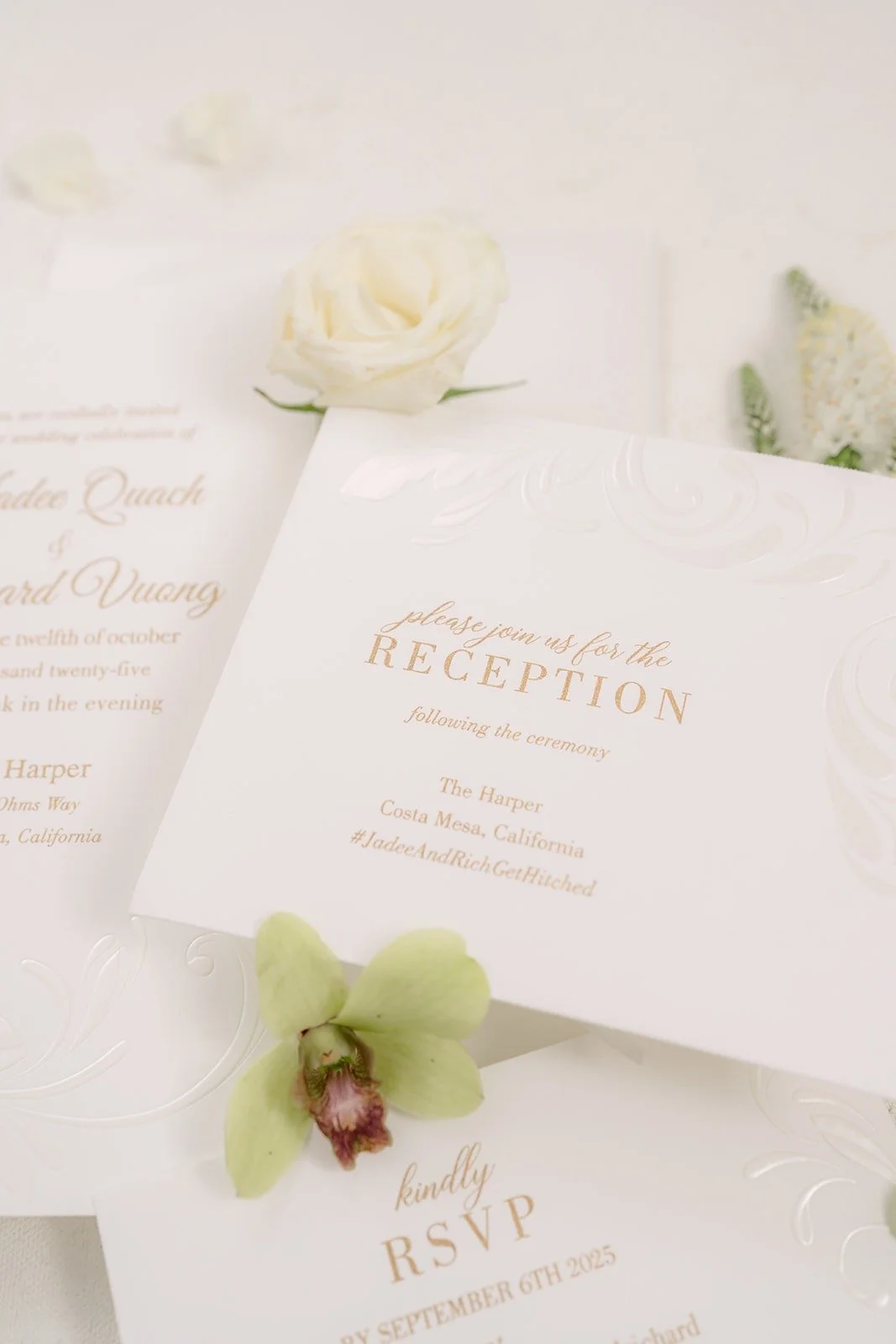 Wedding invitation suite with a reception card and a green orchid