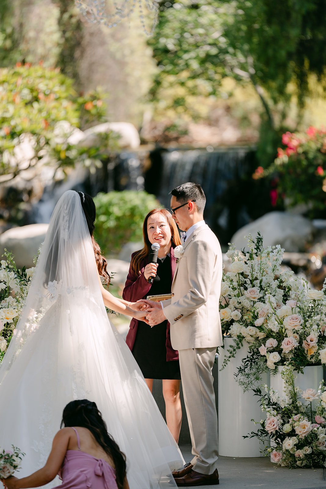 Sandra's cathedral veil trailing behind her at the front of the aisle.