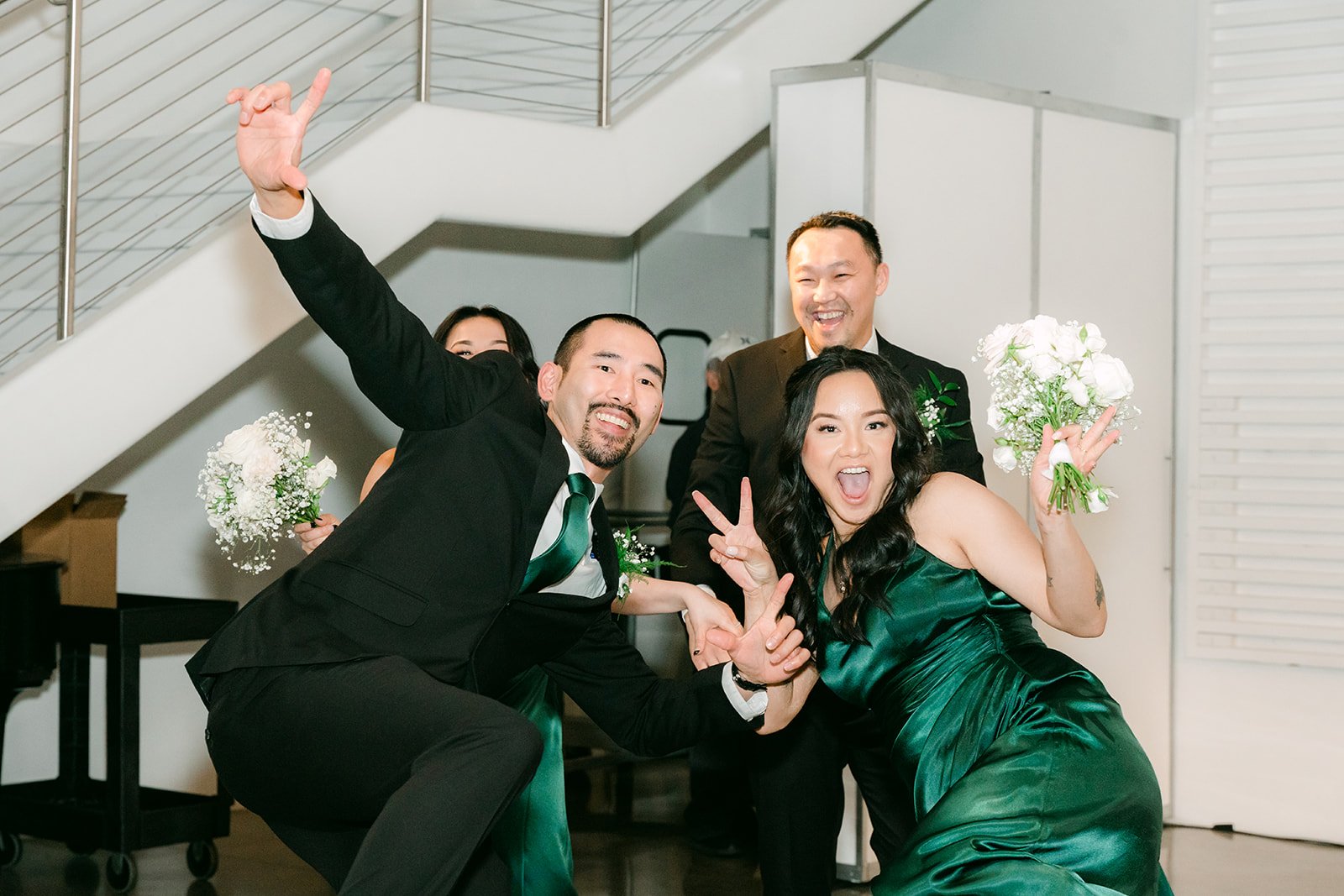 Groomsmen and a bridesmaid striking a pose during the entrance
