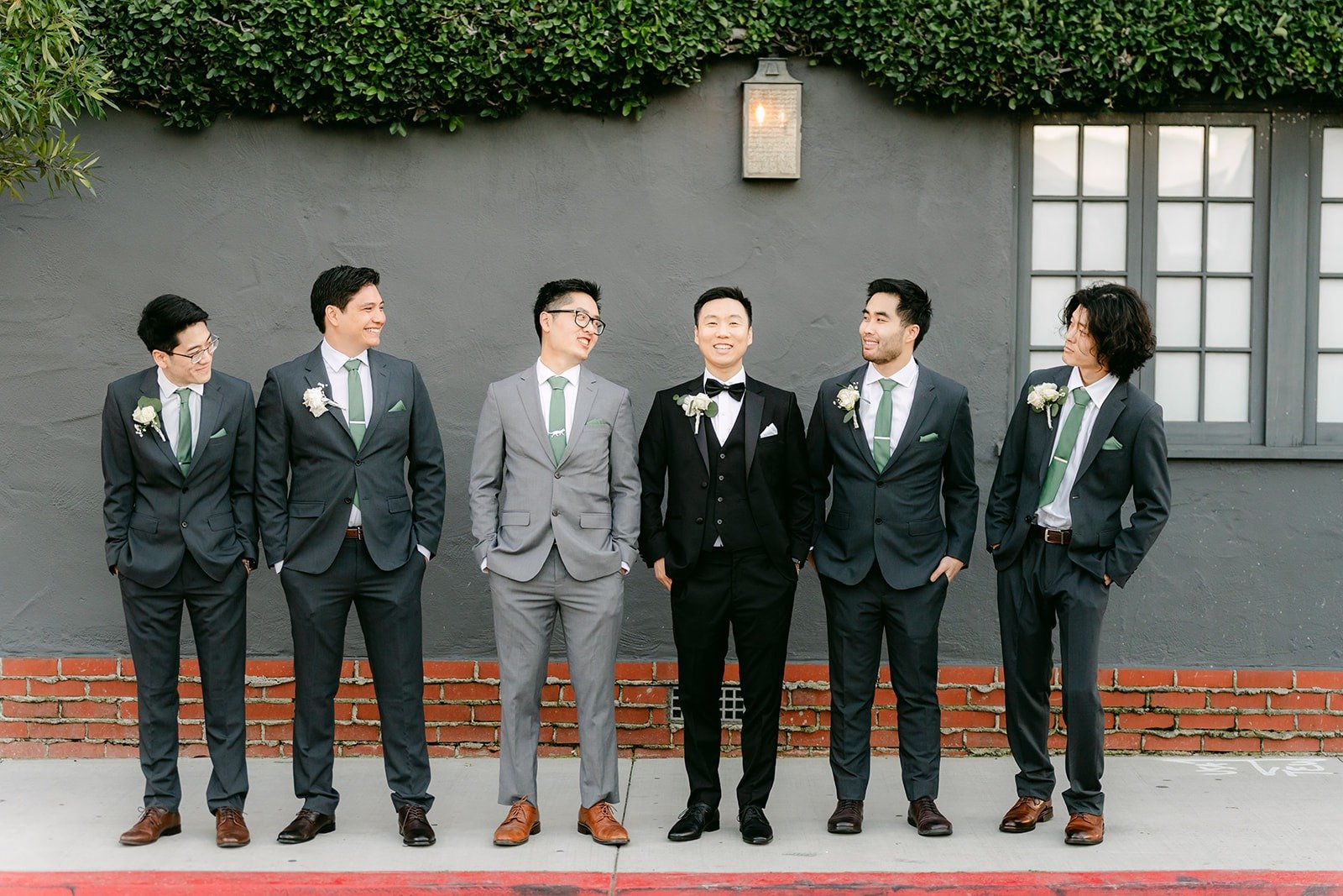 Jason and his groomsmen lined up under the ivy