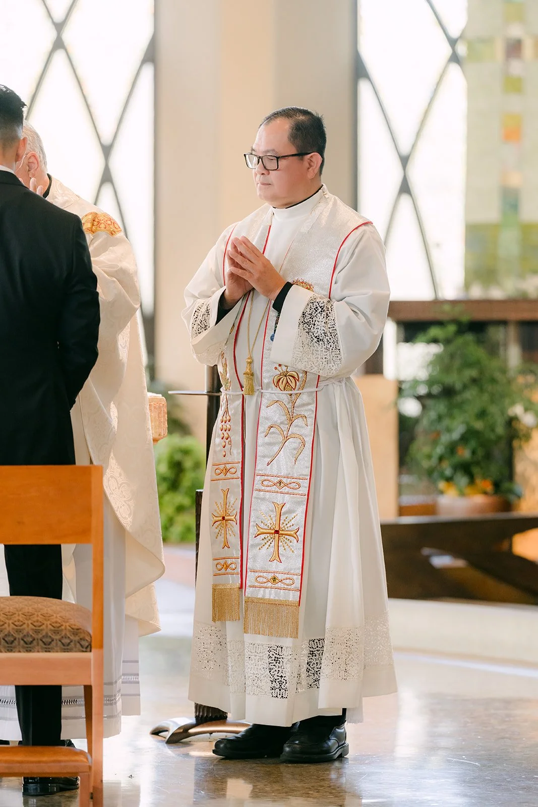 The priest blessing the couple during the mass