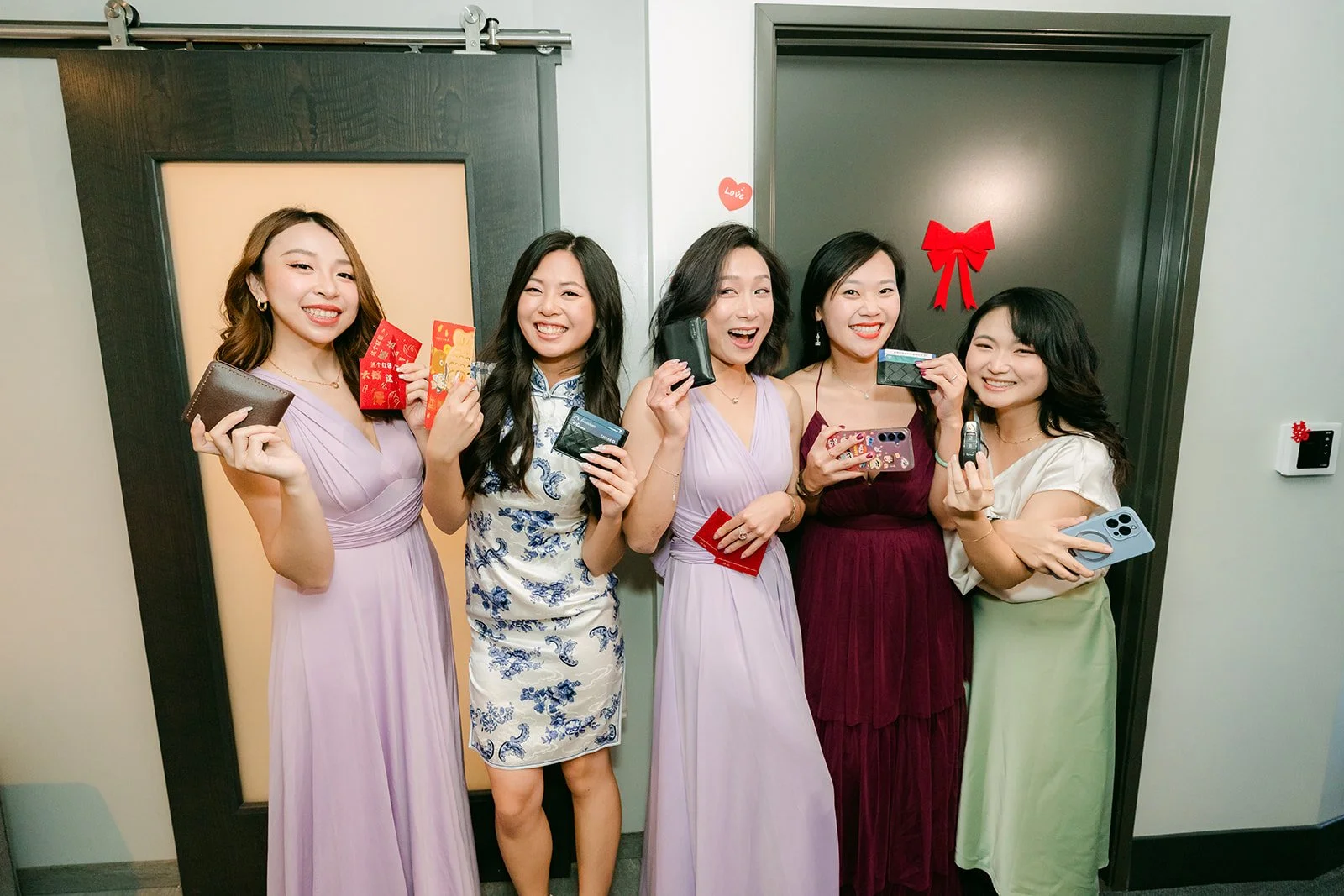 The bridesmaids lined up and laughing at the door.