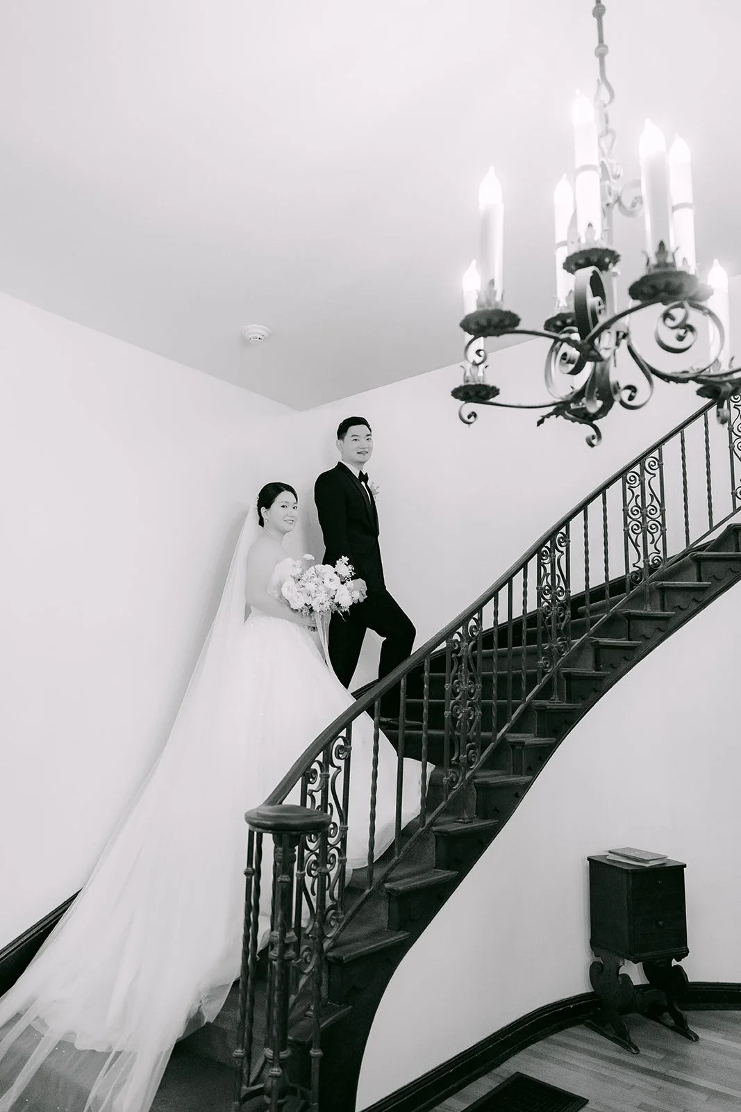 Amy and Sam on the curved staircase inside the Muckenthaler mansion