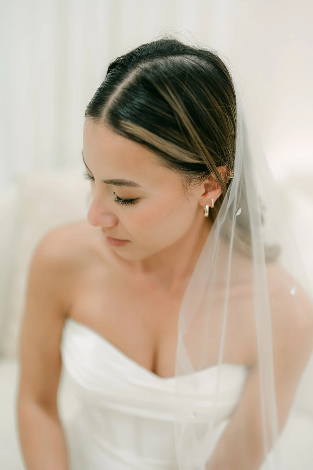 Close up of the bride in her veil looking down over her shoulder