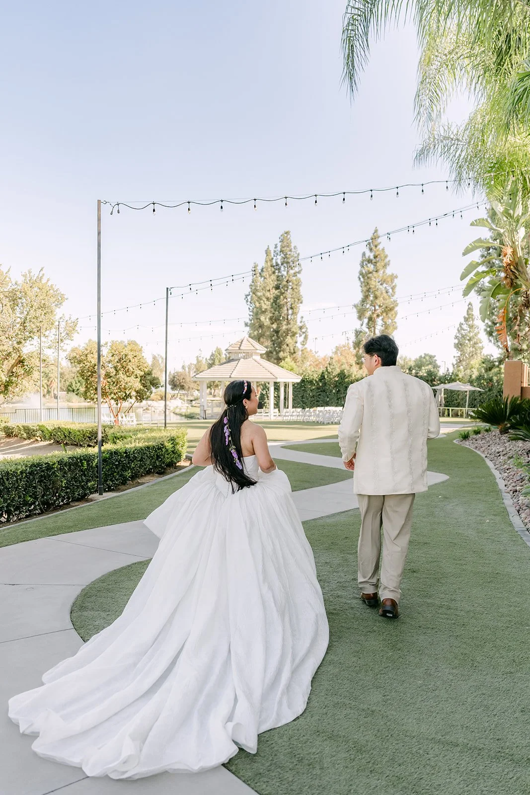 Angela and Jacob walking hand in hand at Almansor Court