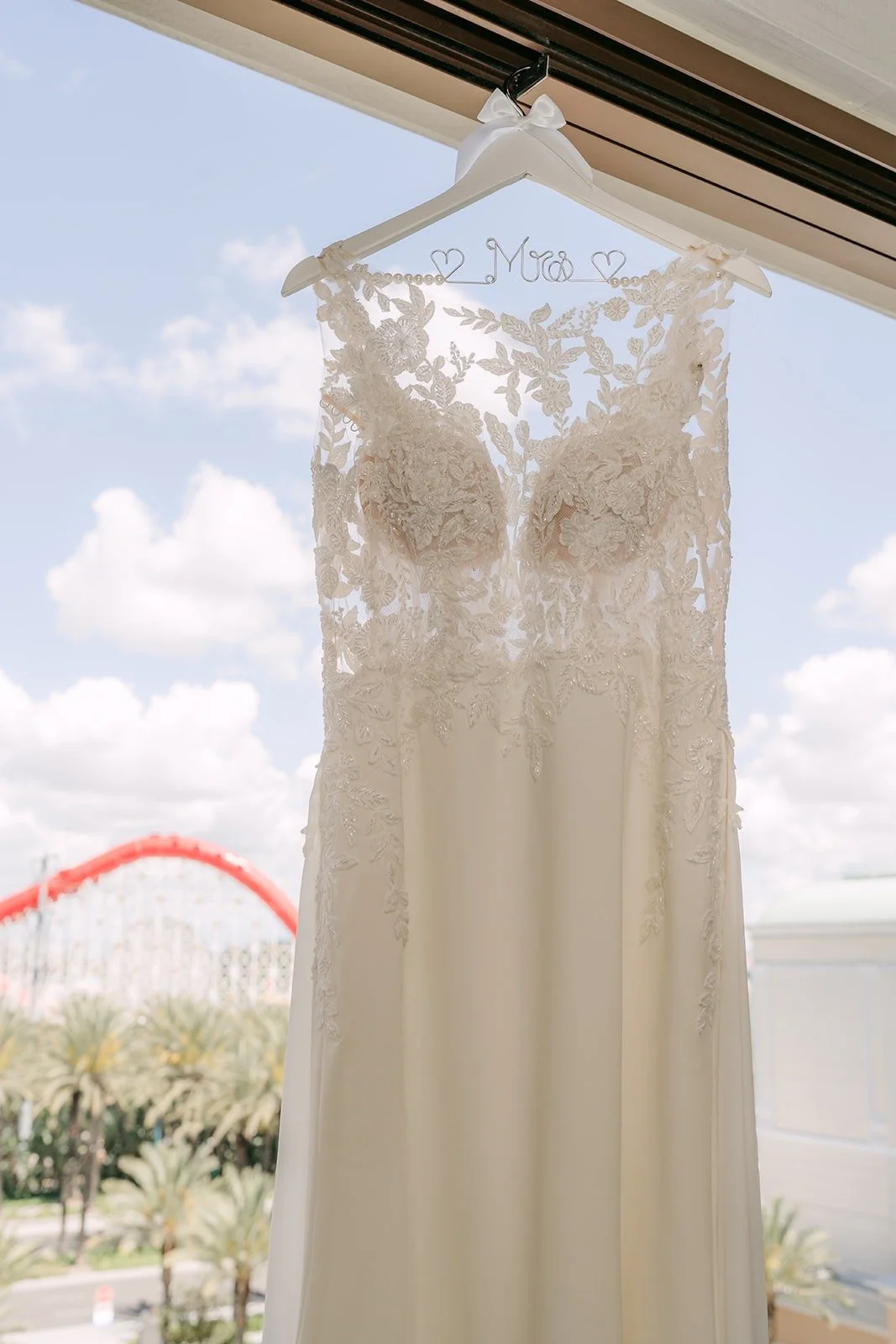 Francesca's lace wedding gown hanging in the window of the Bride Suite