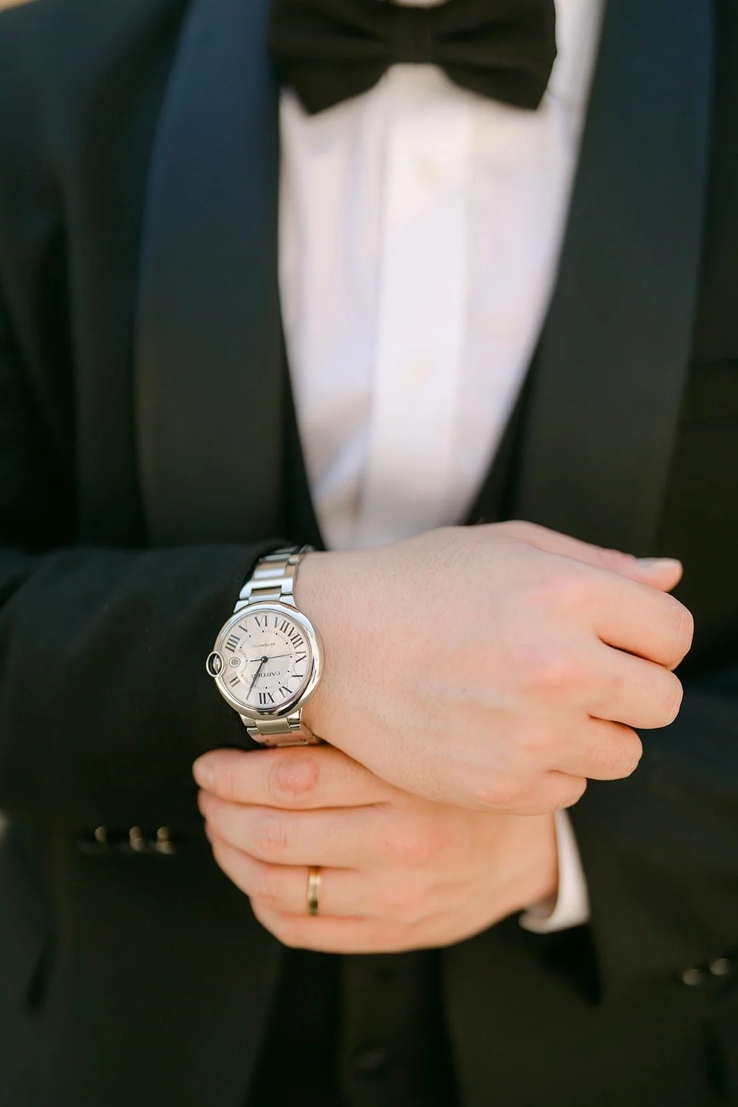 A close look at Min Soo's watch and cuff as he fixes his sleeve
