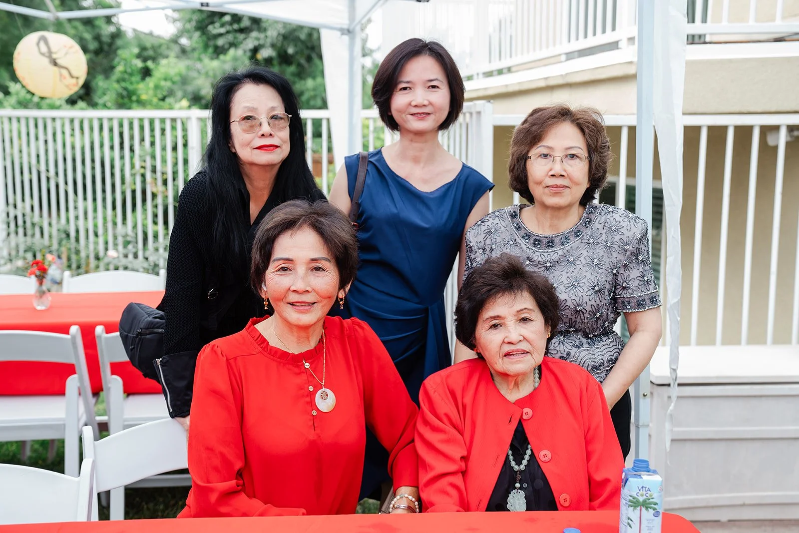 Relatives smiling together in the backyard.