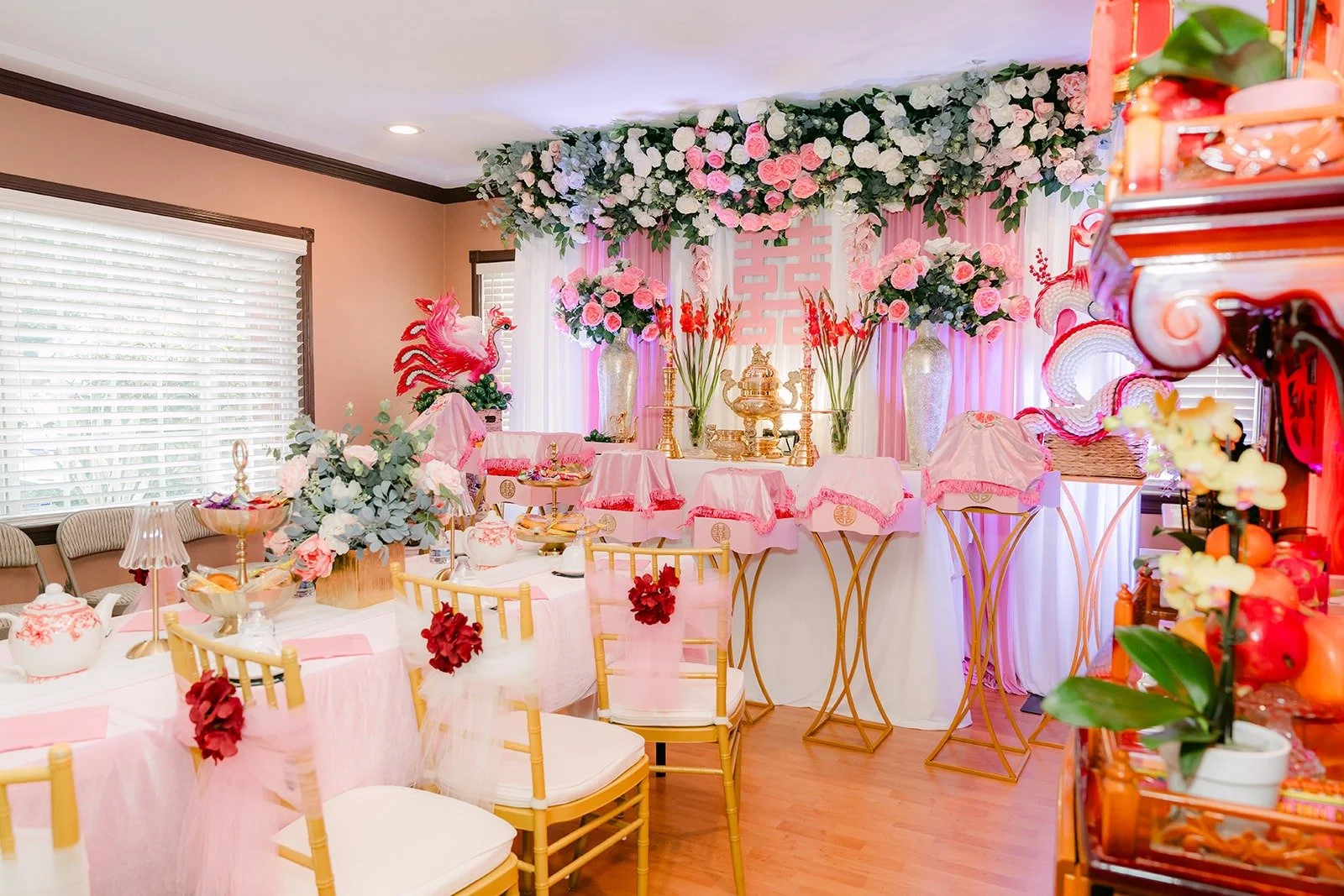 The family living room set for the tea ceremony with a pink floral backdrop