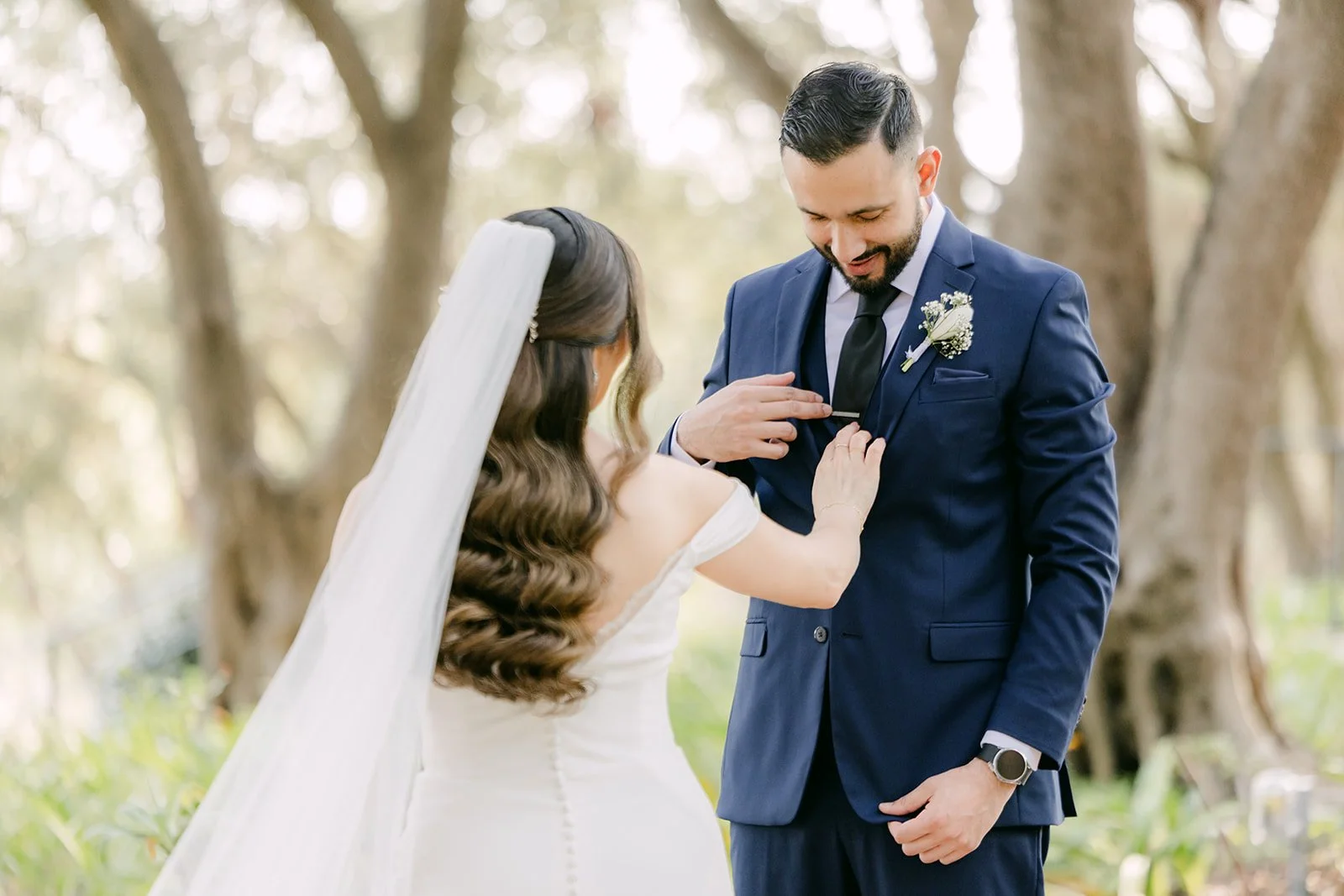 Mariana adjusting Danny's boutonniere