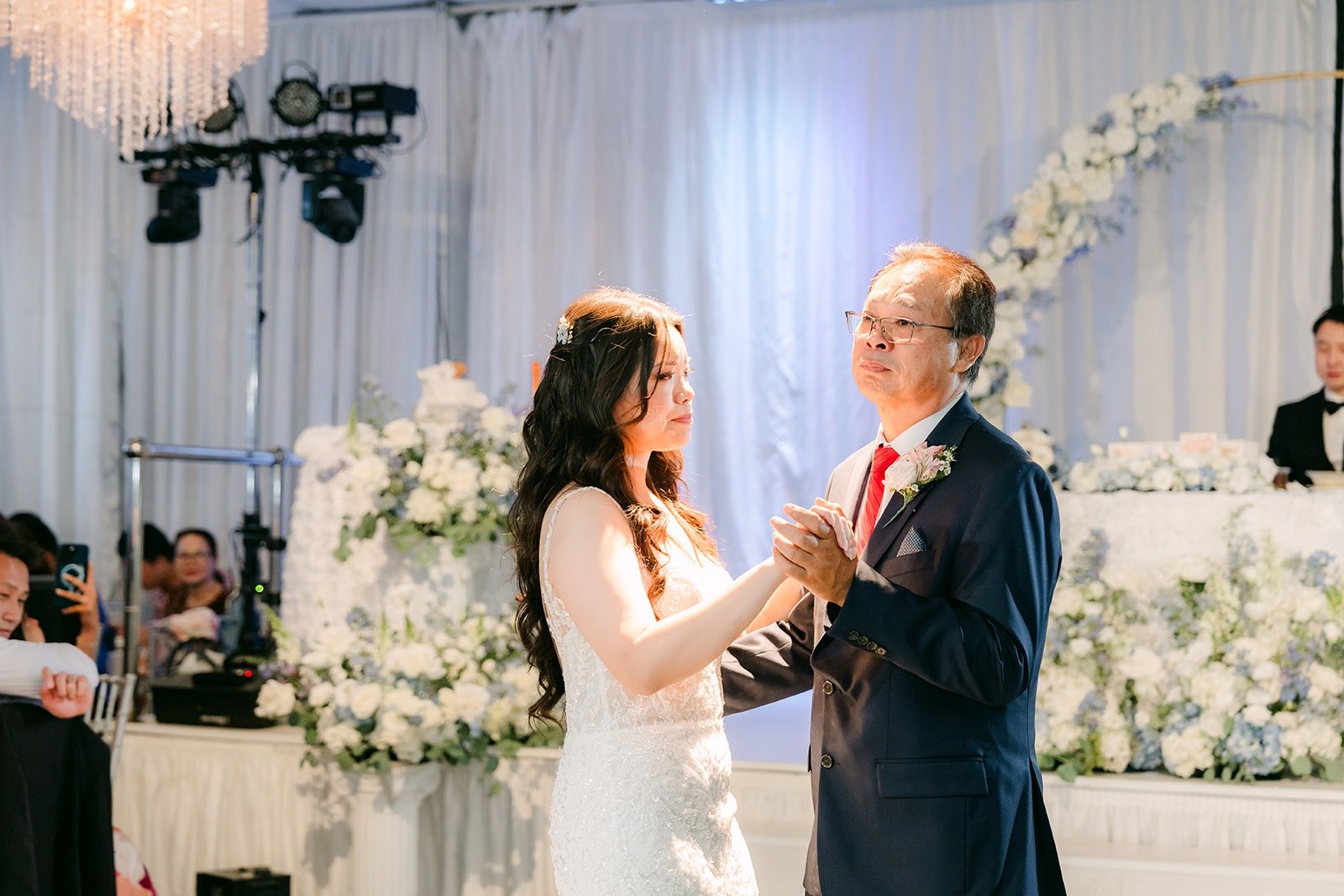 Emily and her dad sharing a dance at the front of the room
