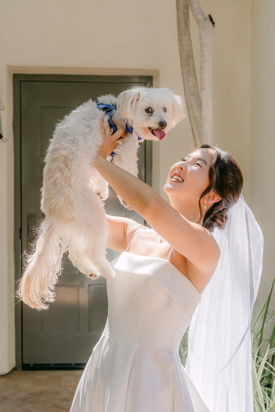 Saya lifting her pup overhead in celebration