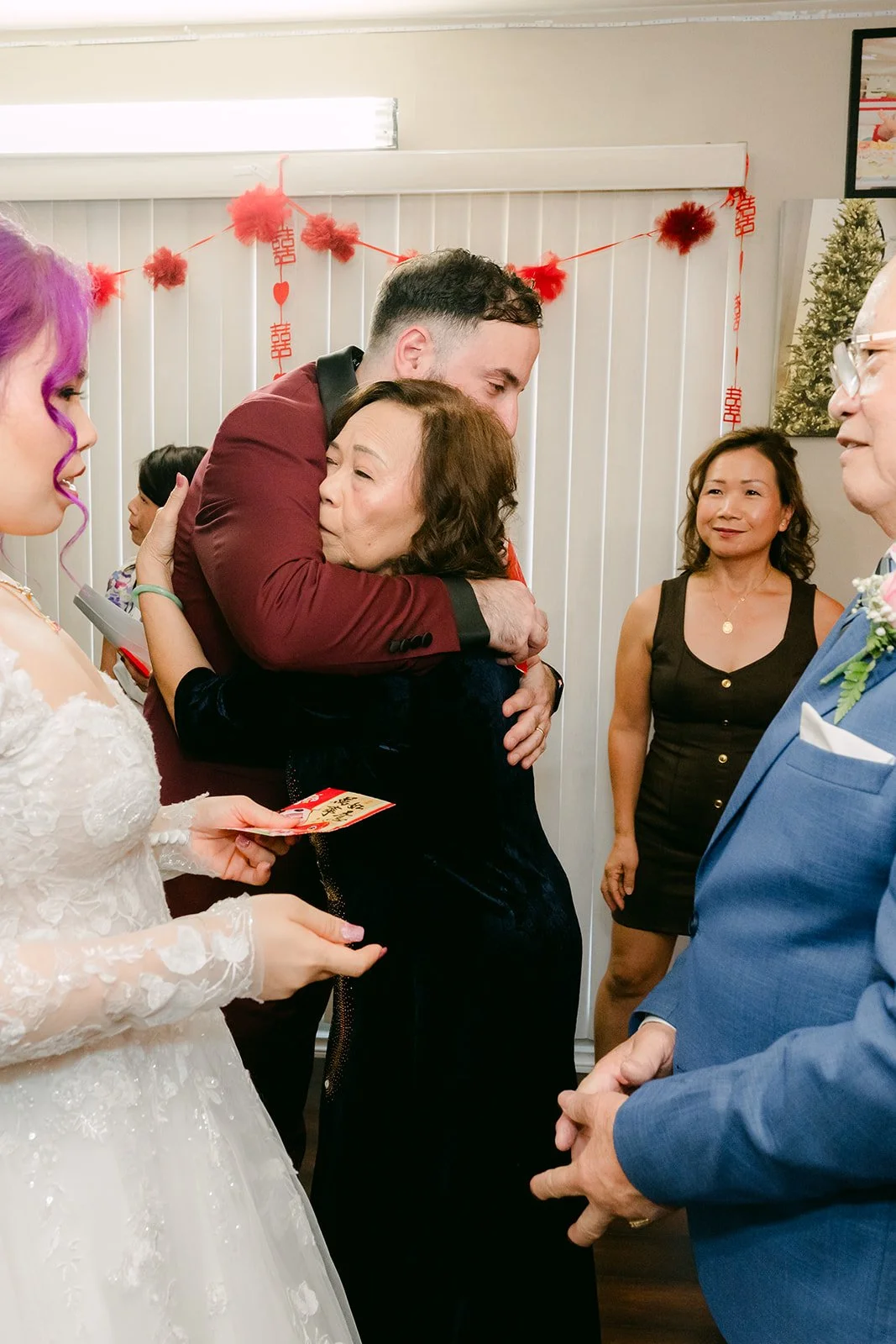An aunt hugging Vanessa during the tea ceremony.