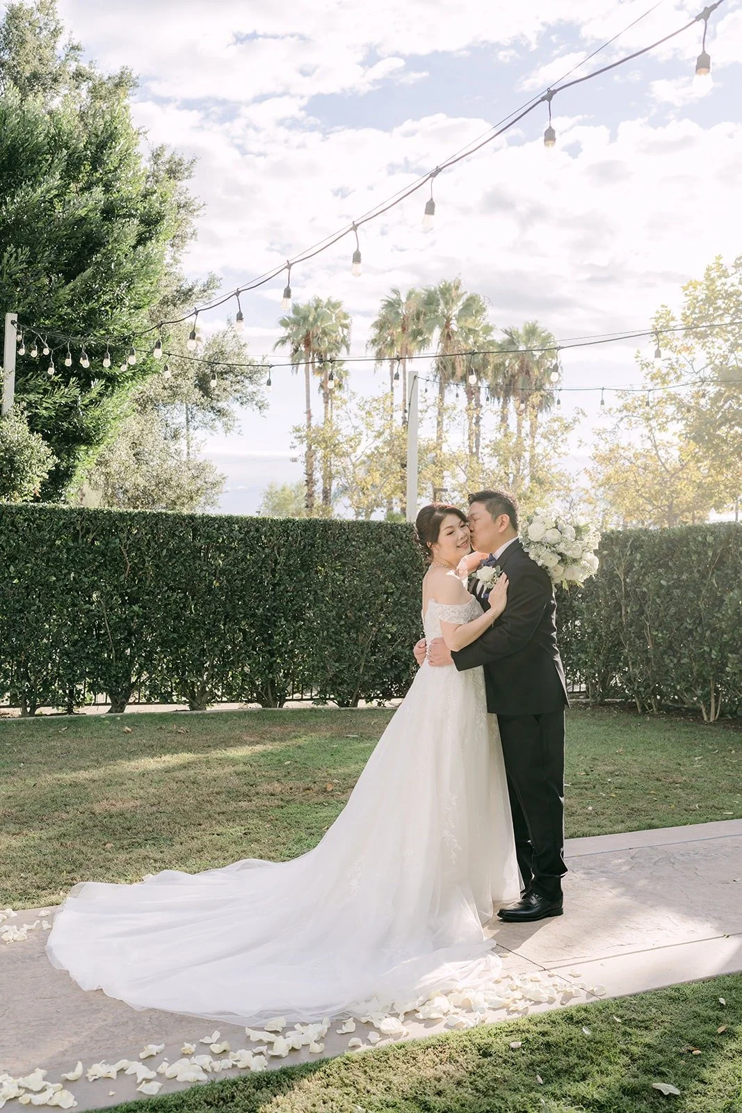 Sochi and Jay share a kiss on the lawn at Sierra La Verne, photographed by One and Only Production