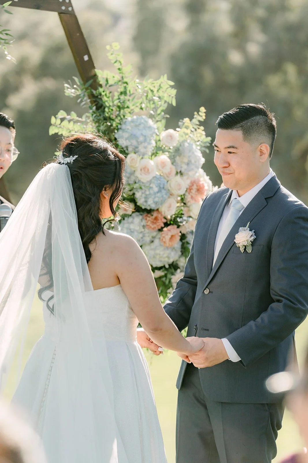 Florence and Jordan holding hands during the ceremony