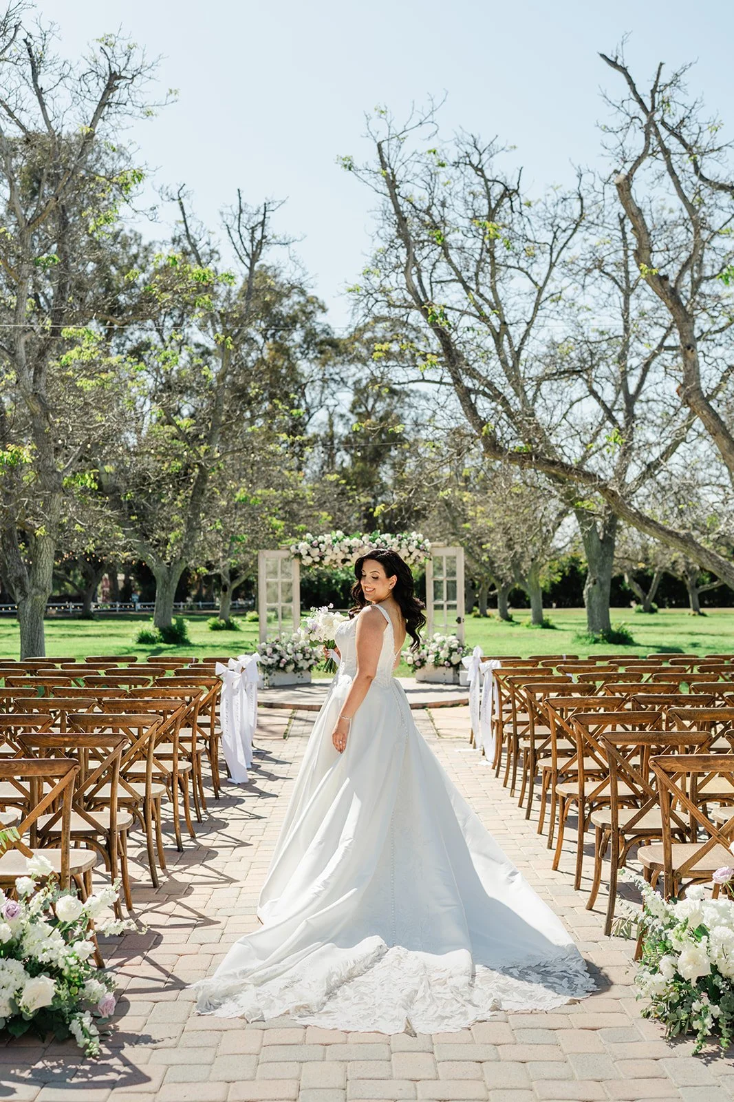 Bride standing at the end of the ceremony aisle at The Walnut Grove