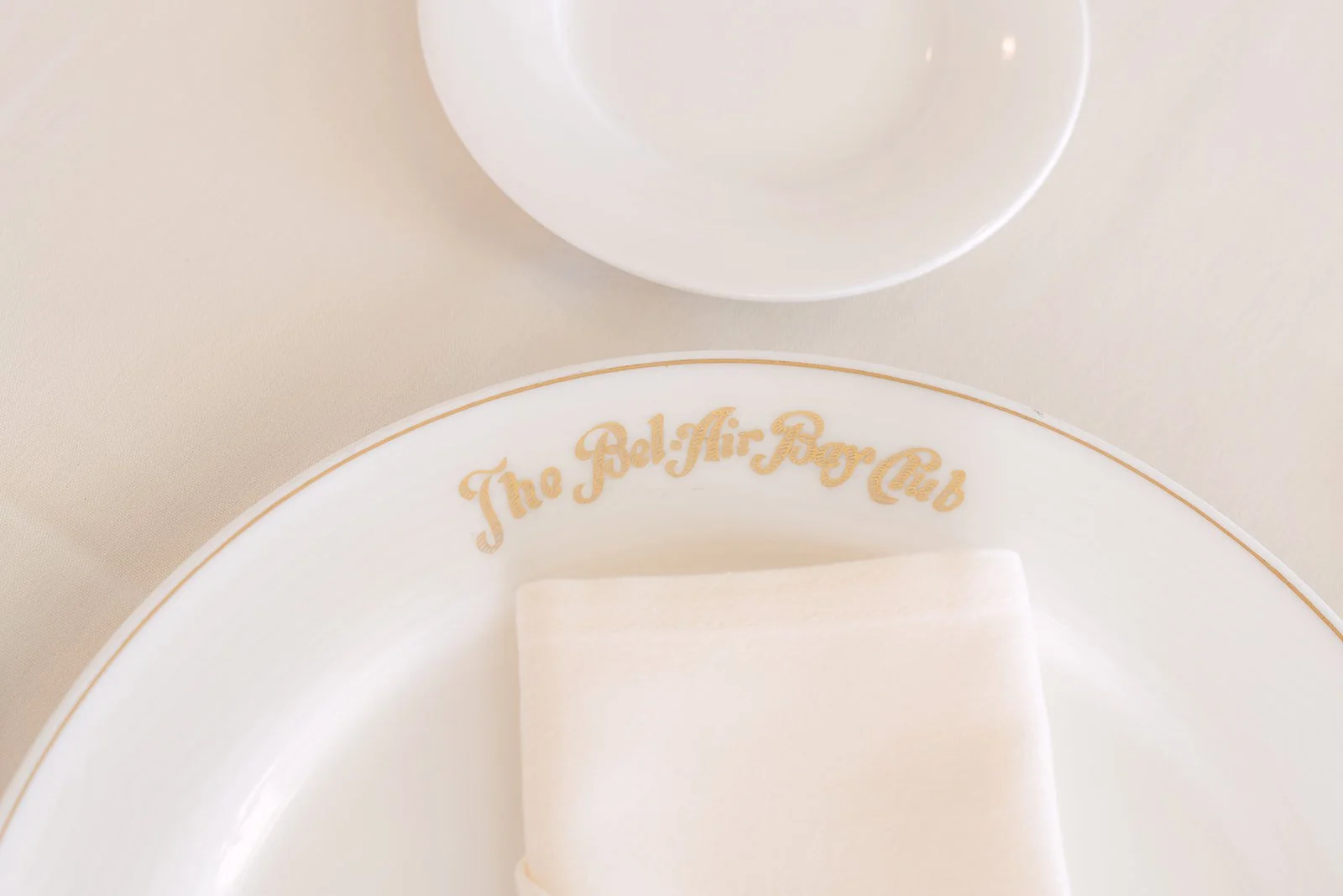 Bel-Air Bay Club monogrammed charger plate with a folded napkin
