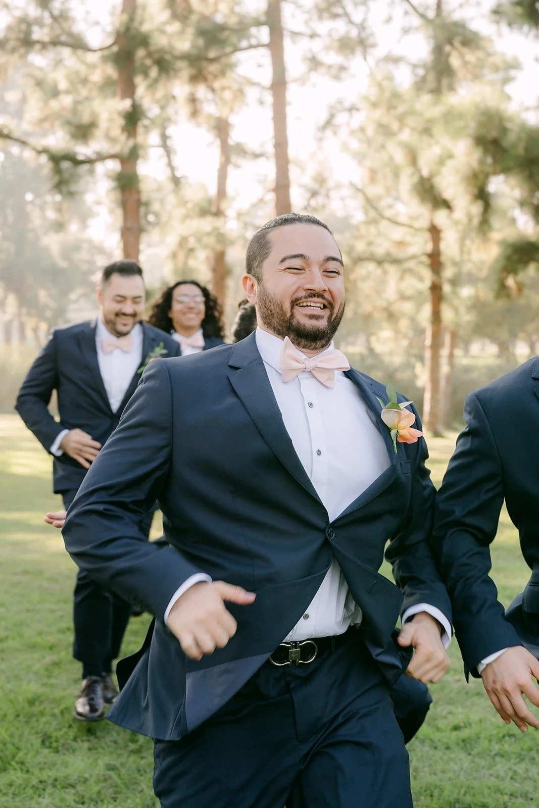 James walking toward the camera with his groomsmen behind him