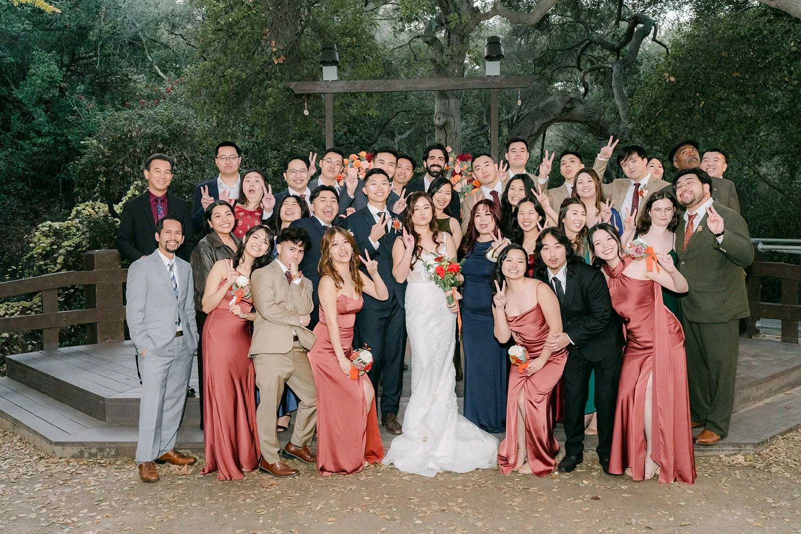 Shayna and Robert with a big group of family and friends at the ceremony site, photographed by One and Only Production