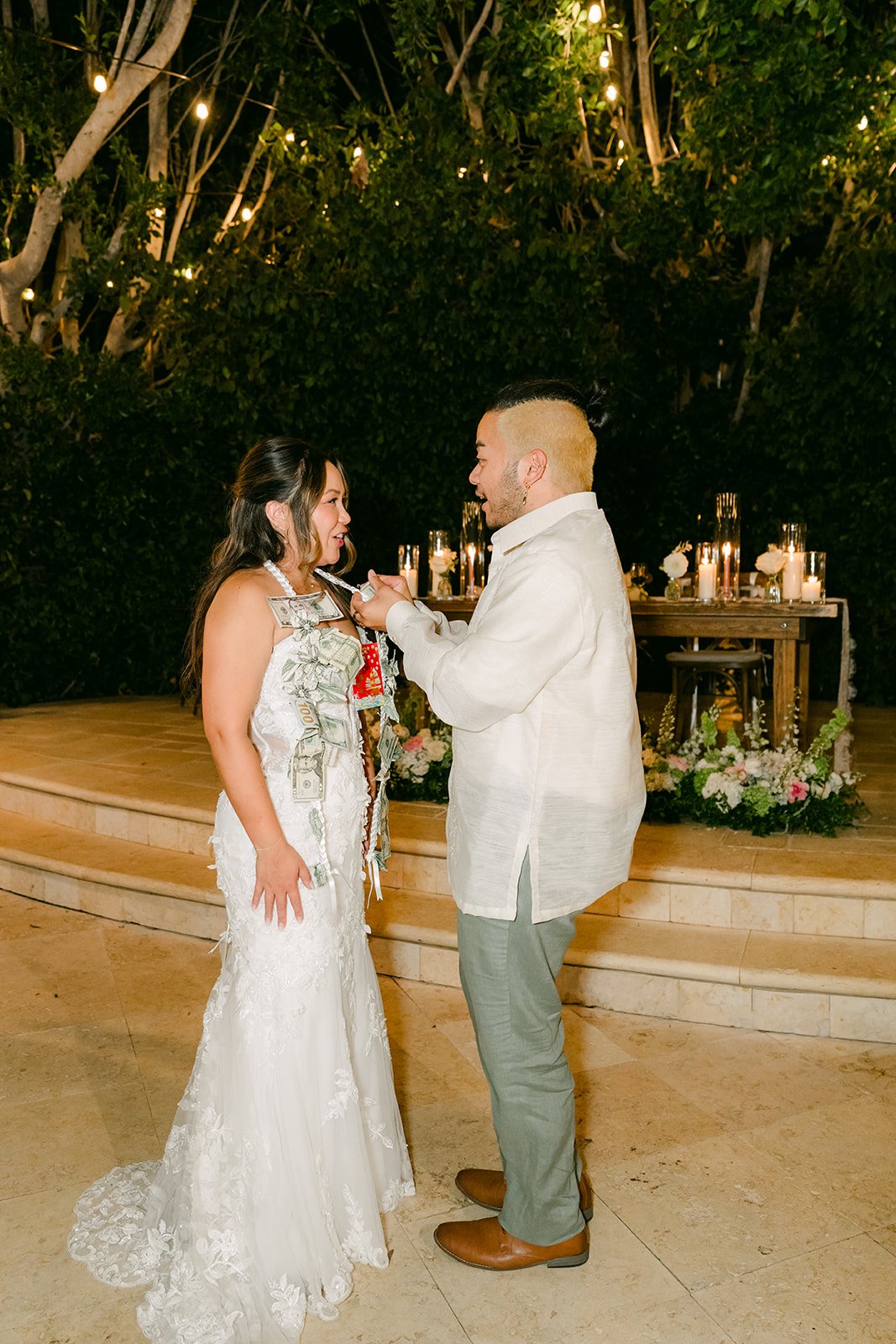 Nicole sharing a dance with a guest under the string lights.