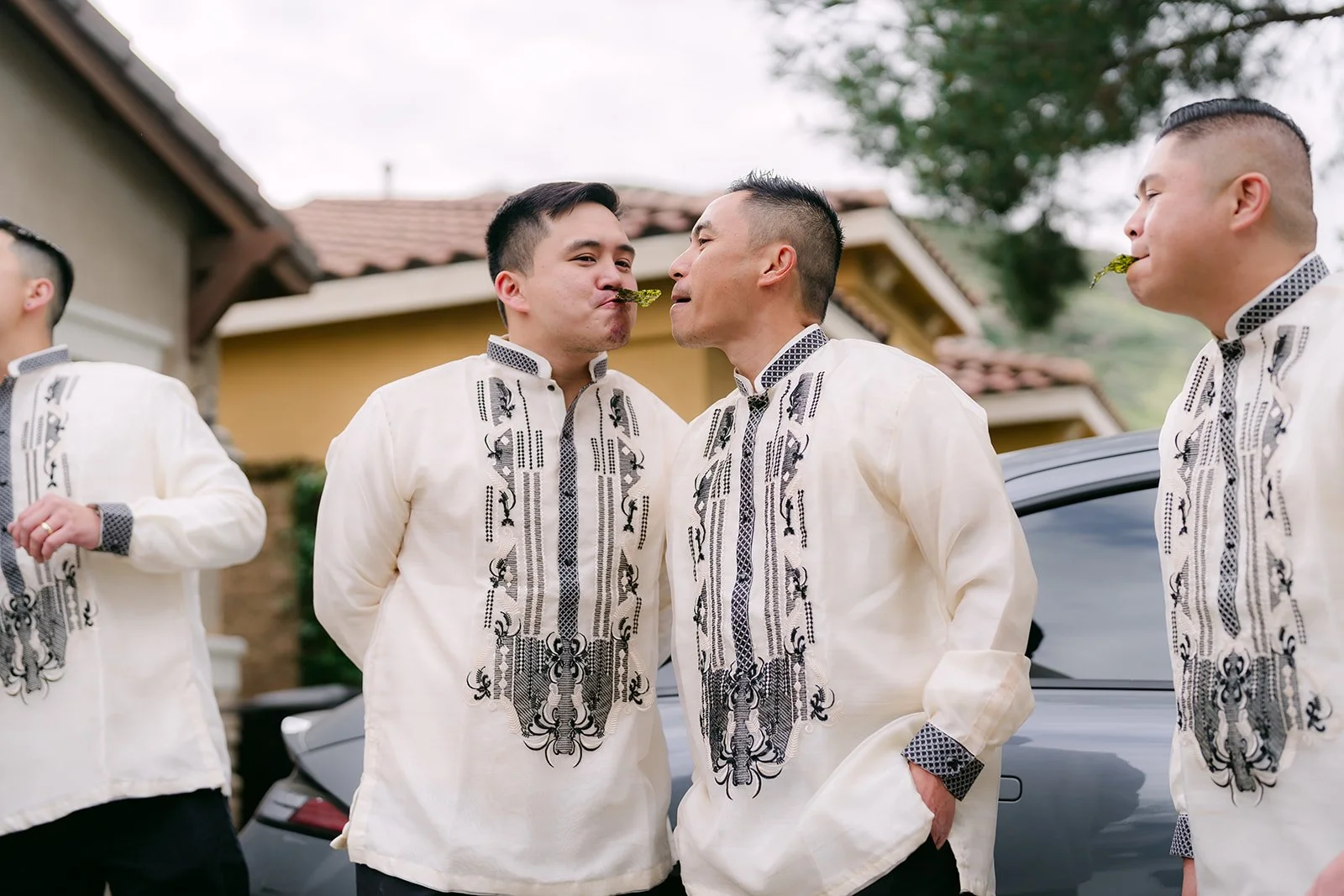 The groom and his groomsmen huddled together planning their way past the bridesmaids.