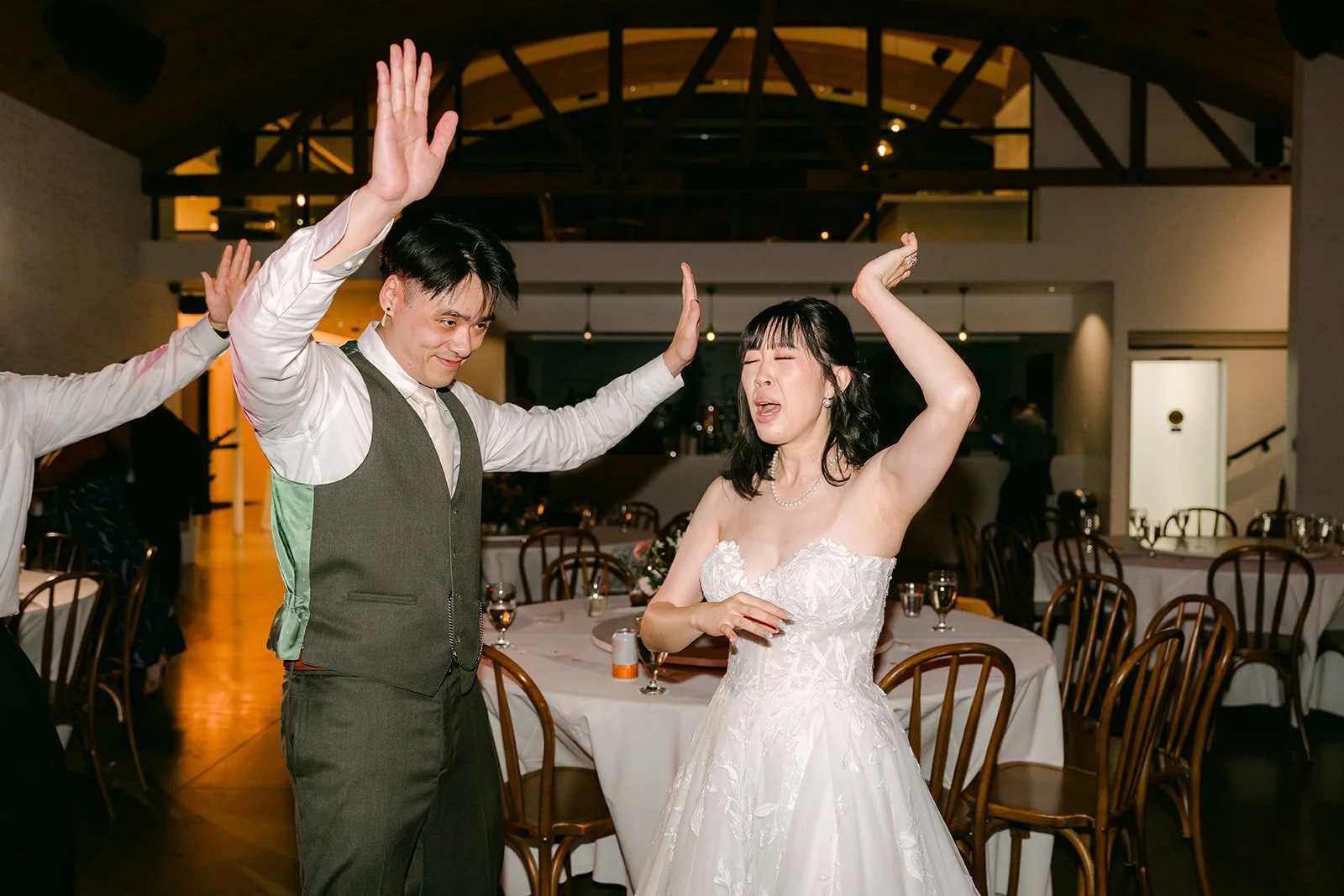 Vivian and Alex dancing with their arms in the air