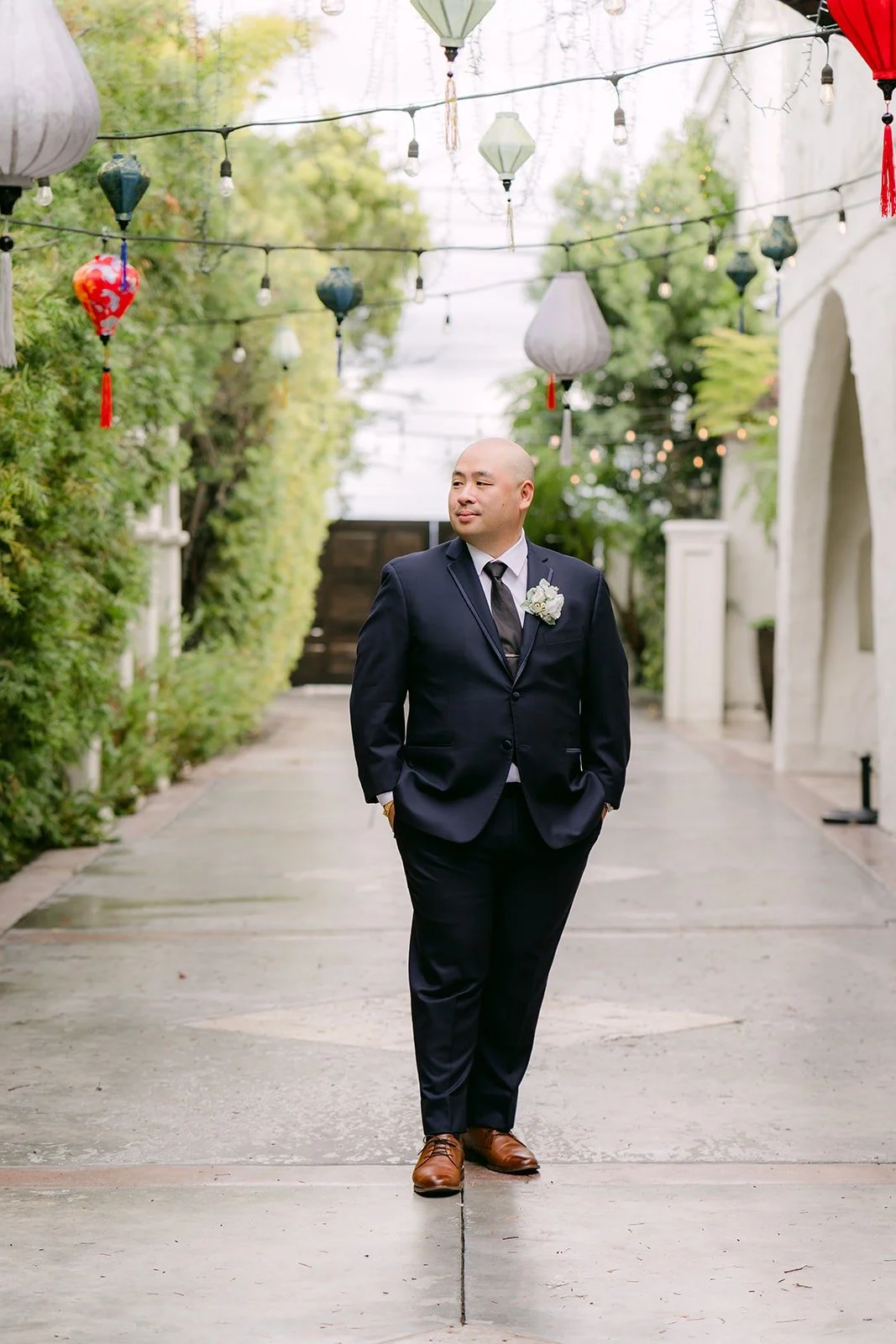 Yao walking down the courtyard path under red lanterns