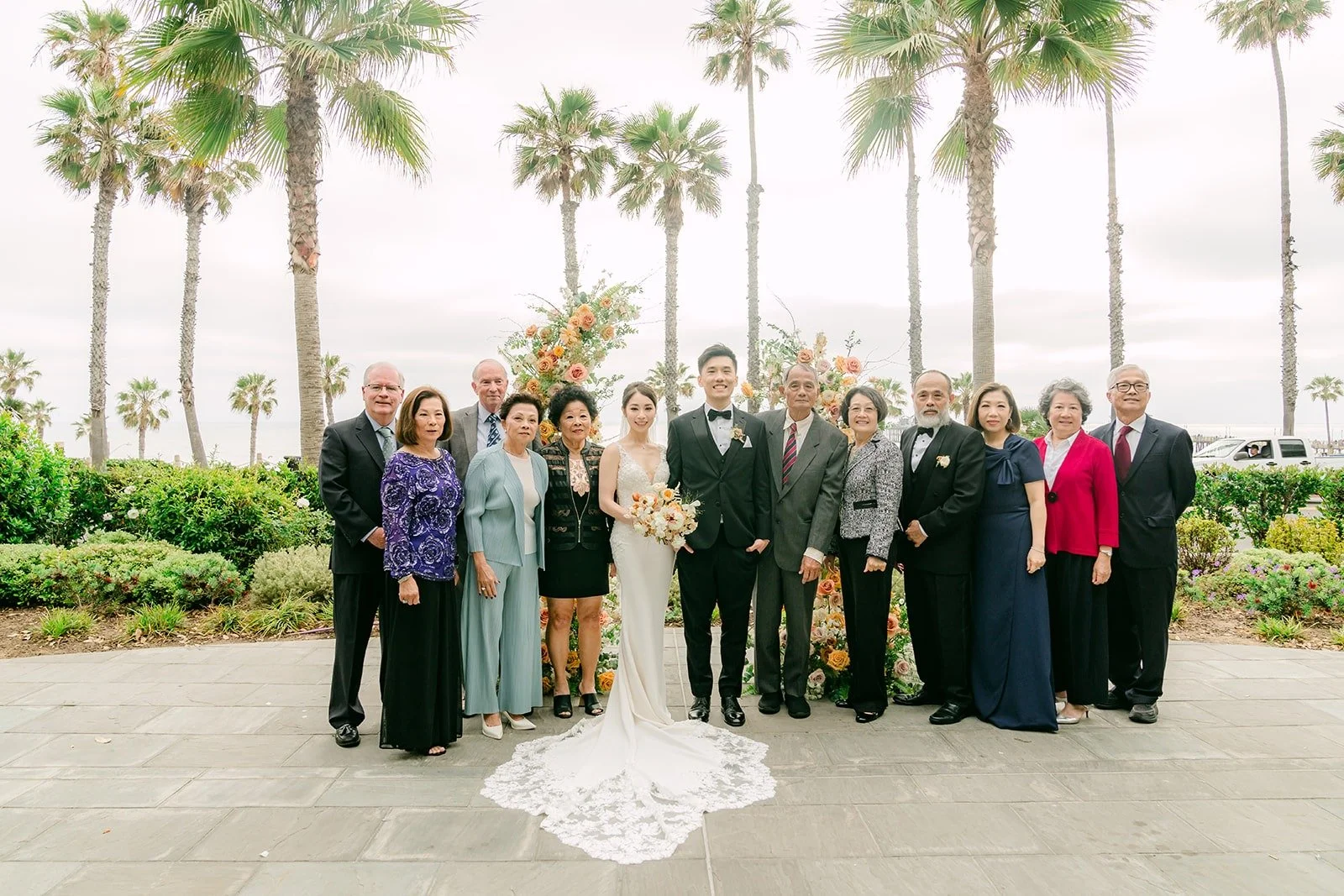 A large family group photo on the terrace after the ceremony